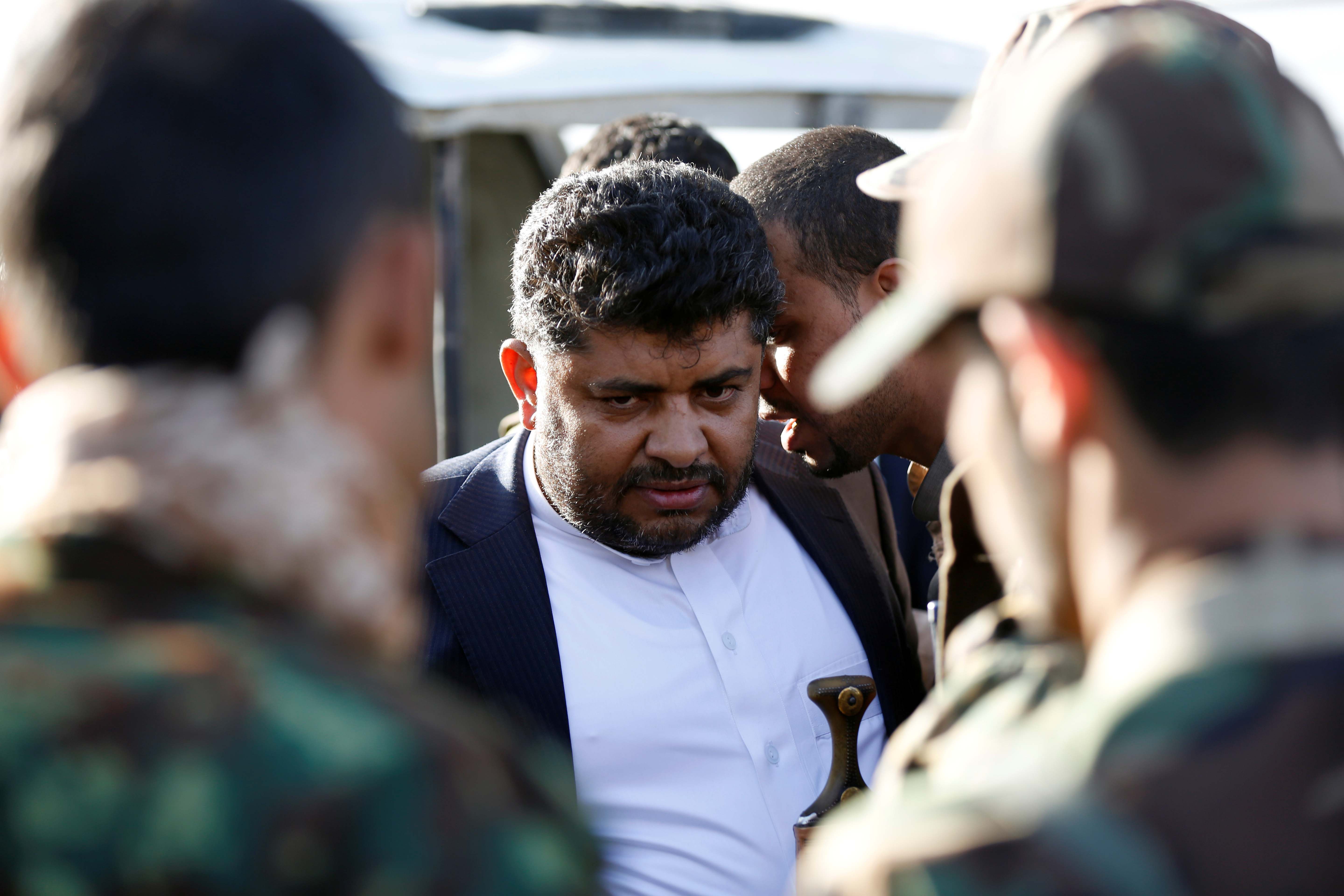 Mohamed Ali al-Houthi, head of the Houthi supreme revolutionary committee, is surrounded by guards as he attends a rally in Sanaa, Yemen