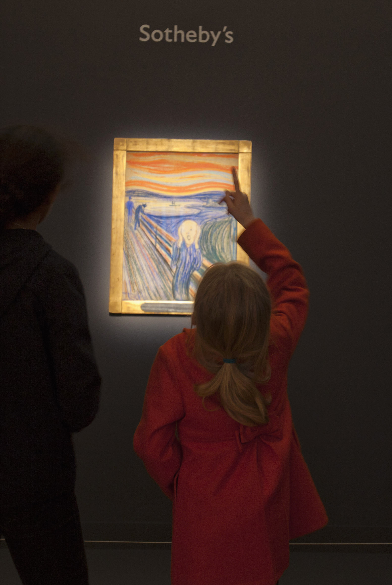 A girl looks at Munch's "The Scream" to be auctioned off May 2, at Sotheby's auction house in New York City