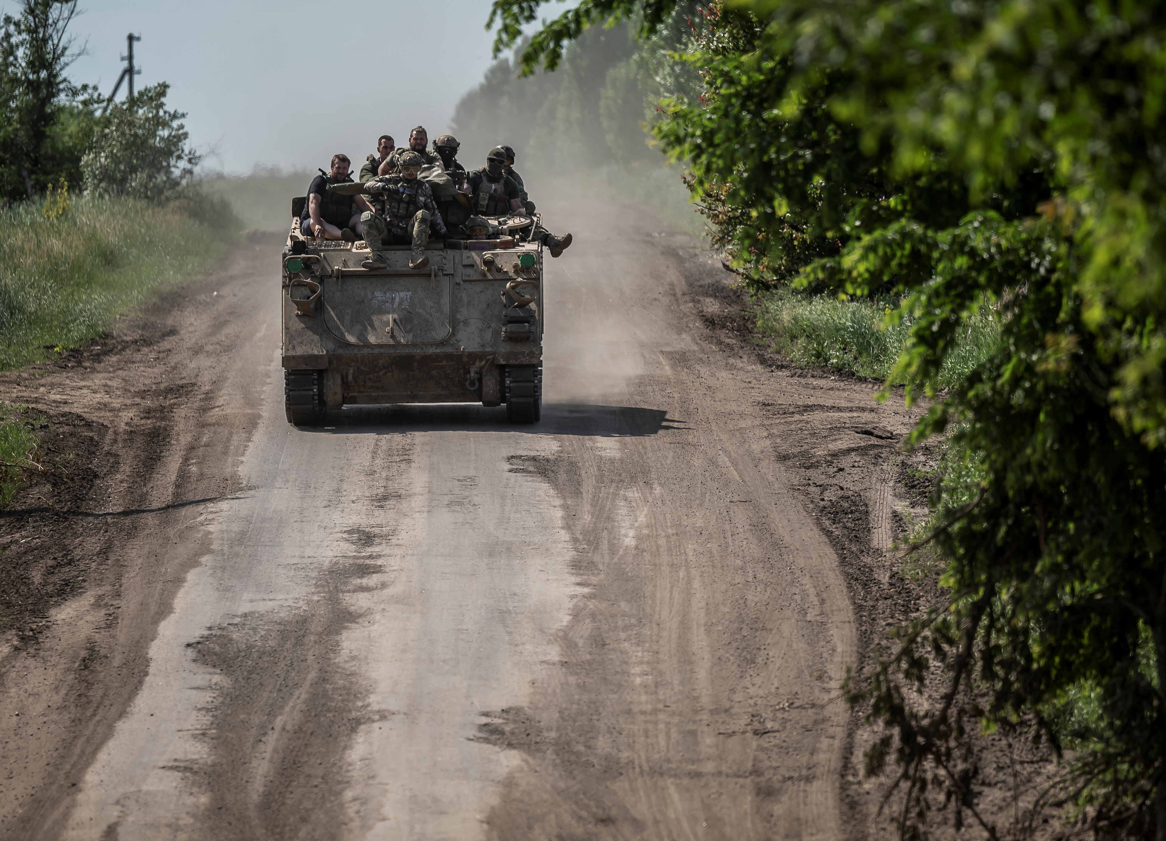 Ukrainian service members ride a M113 armoured personnel carrier near the front line city of Bakhmut