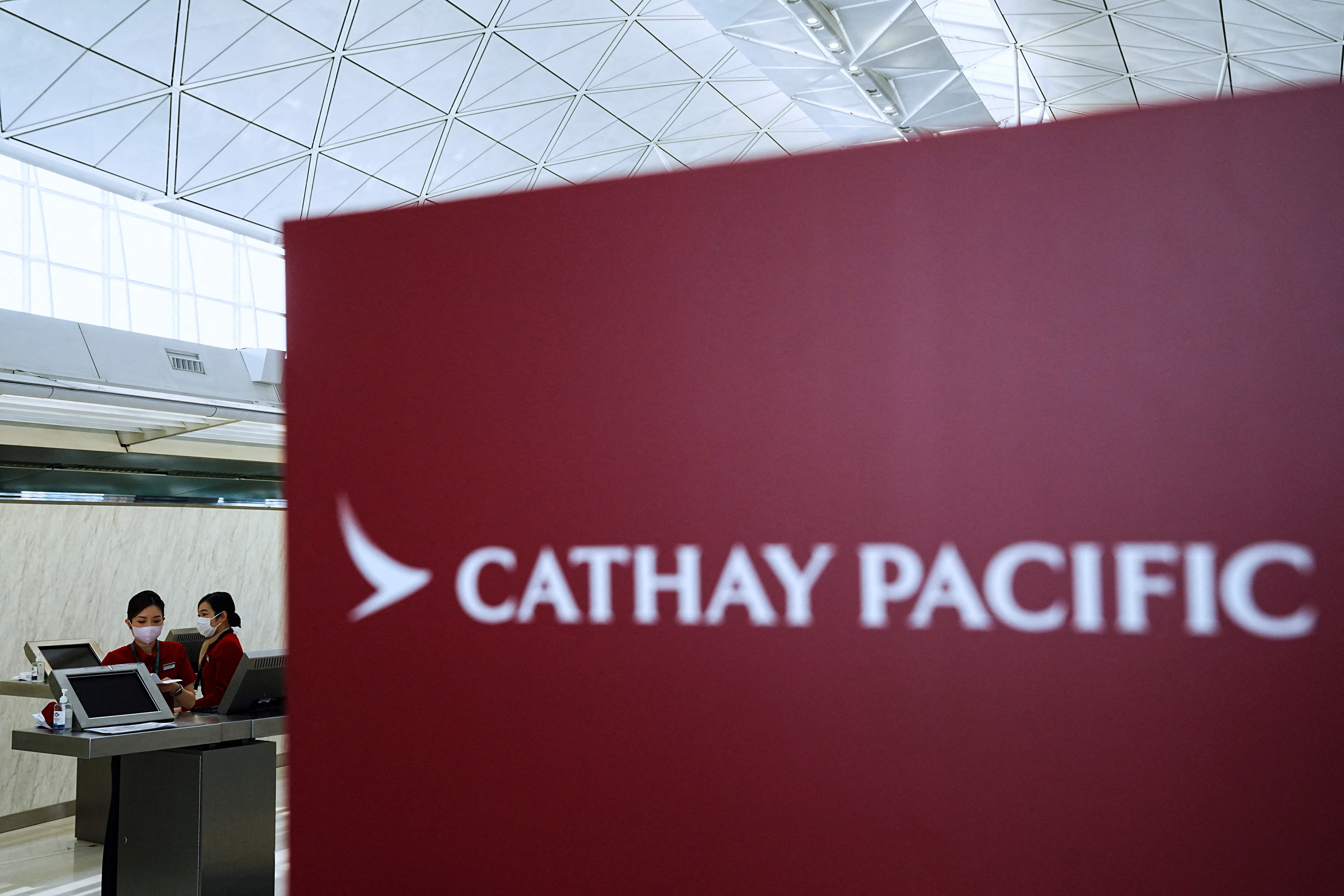 Cathay Pacific employees work at Hong Kong International Airport, in Hong Kong