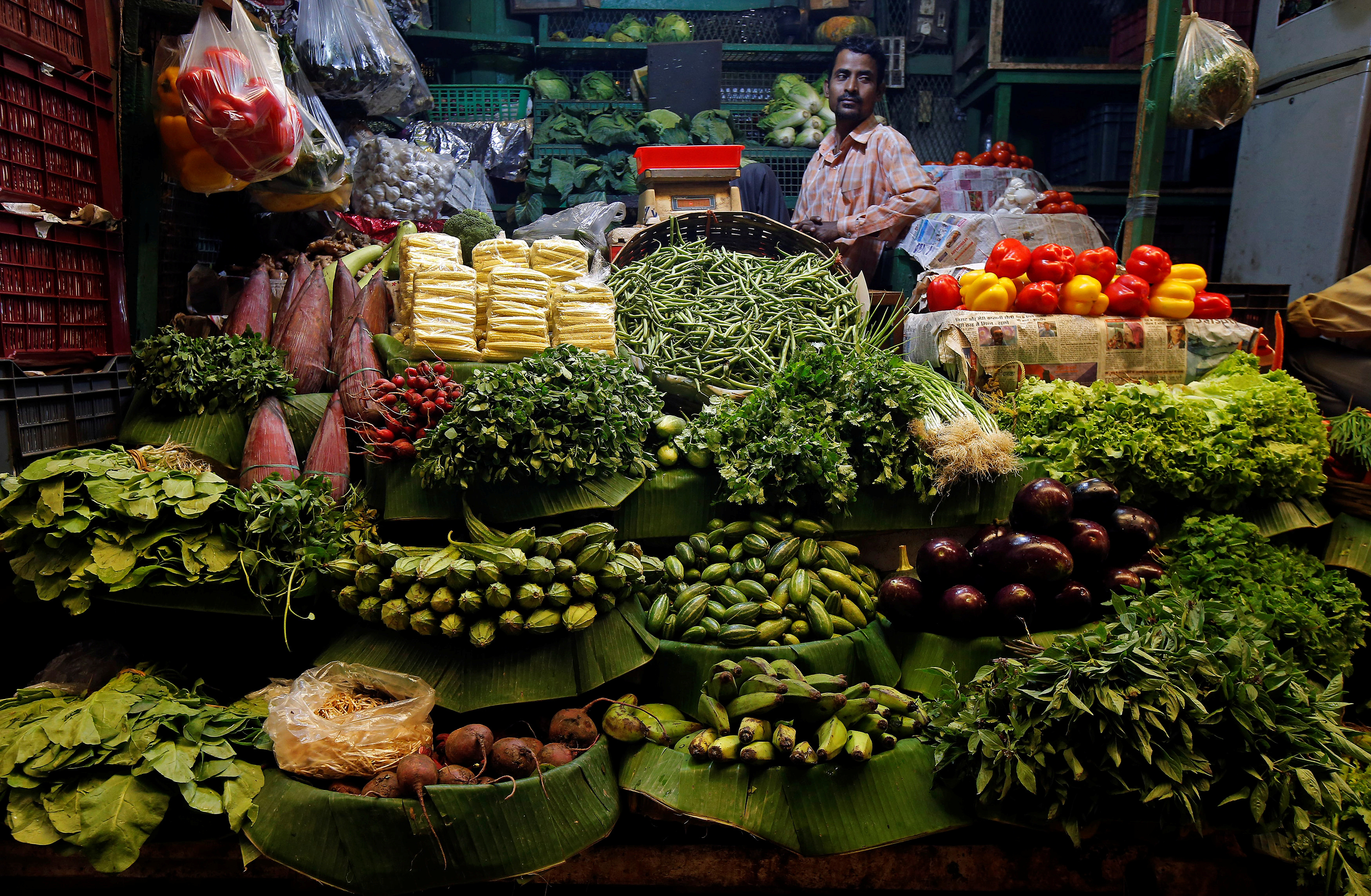 A vegetables vendor waits for customers at a market in Kolkata