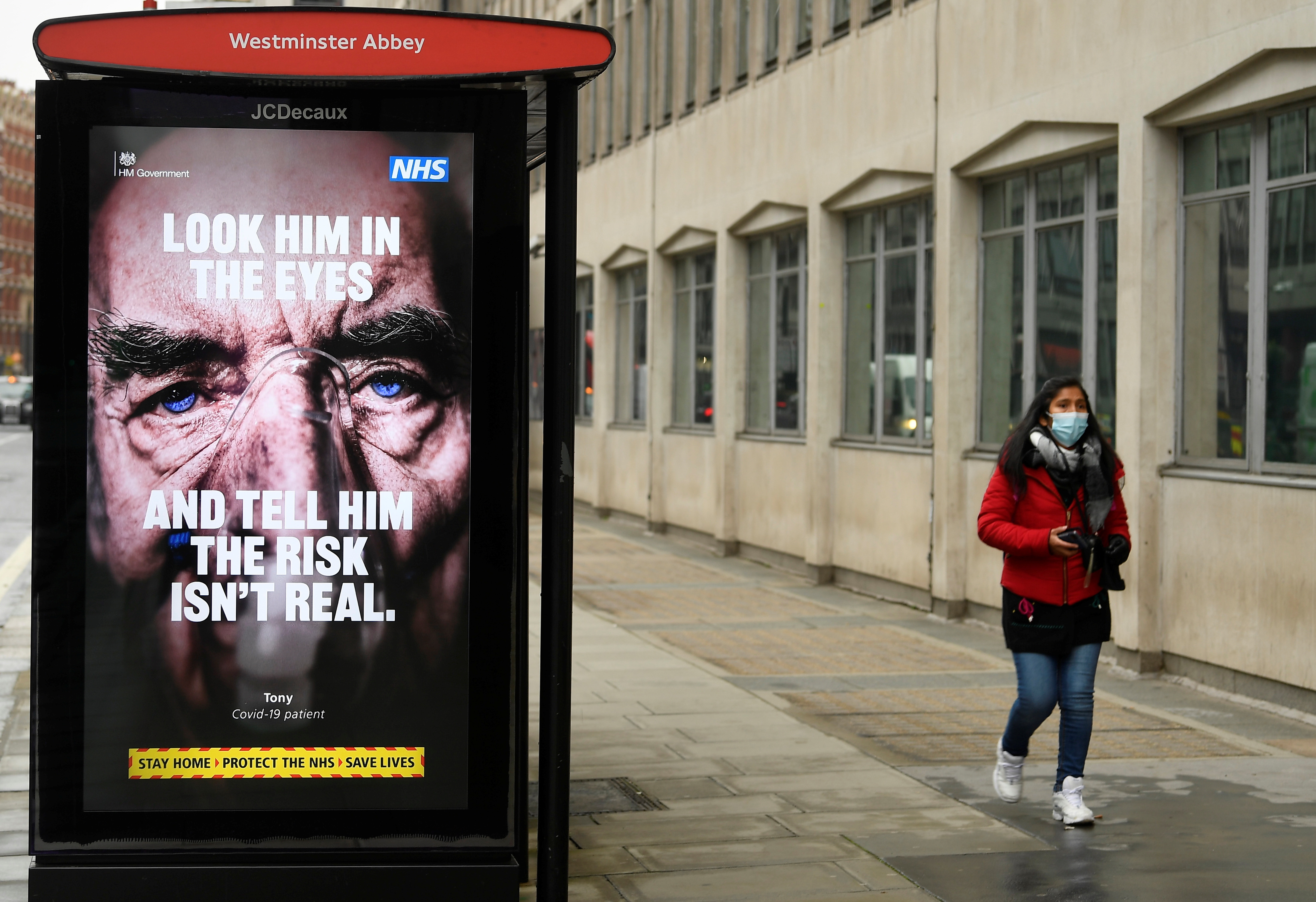 A British government public health information sign is seen on bus shelter in London