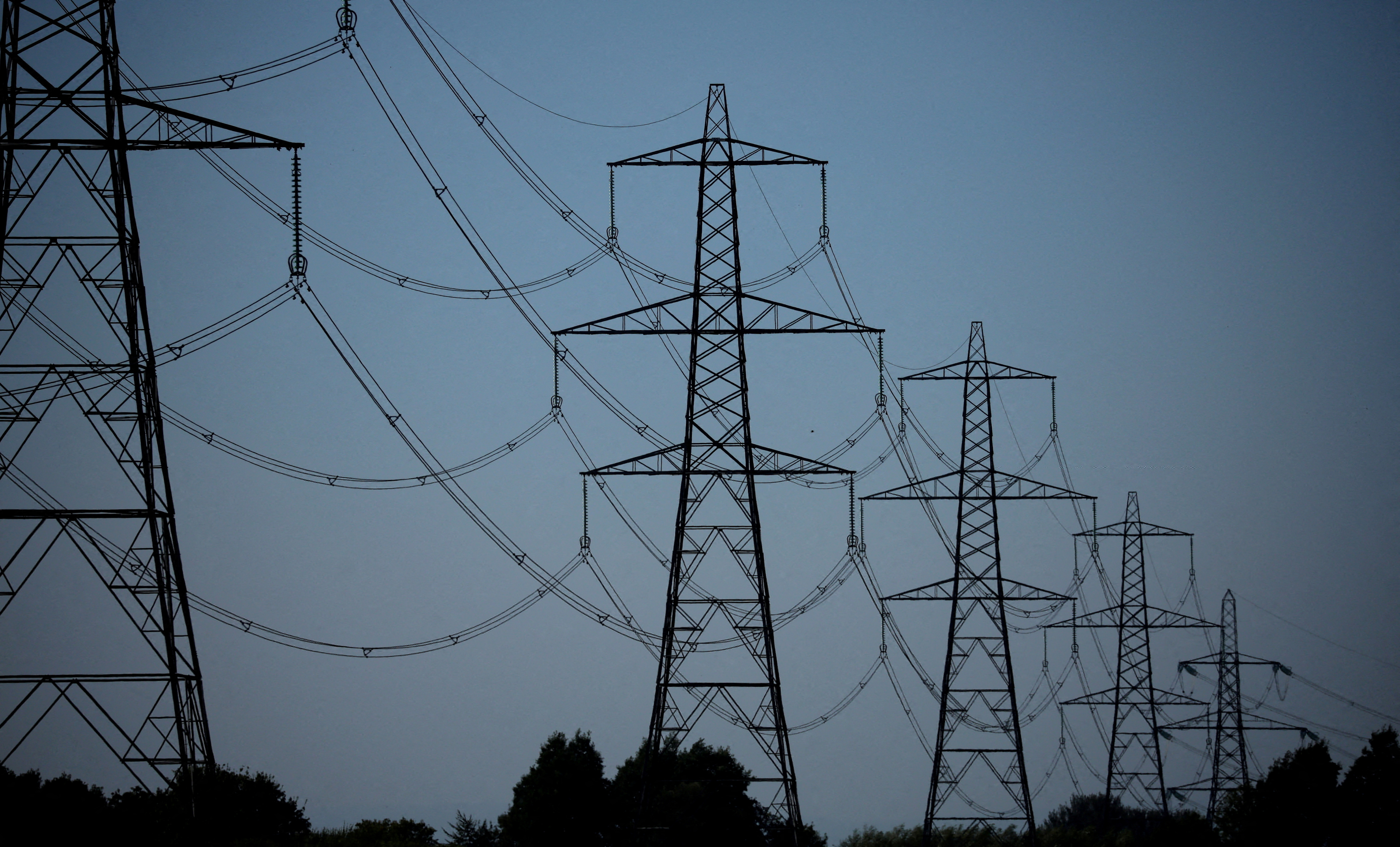 A row of electricity pylons is seen near the Frodsham on shore wind farm in Frodsham, Britain