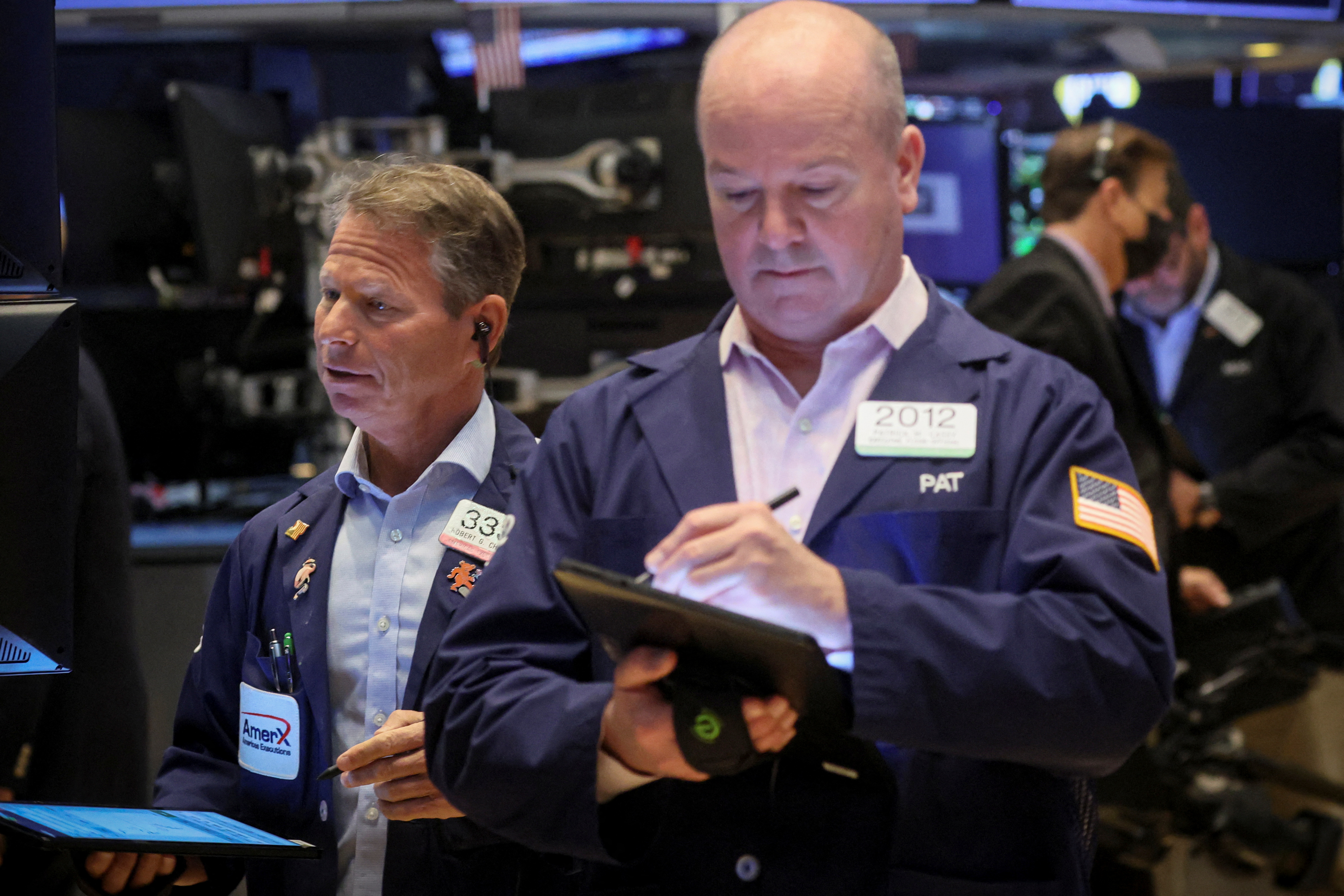 Traders work on the floor of the NYSE in New York