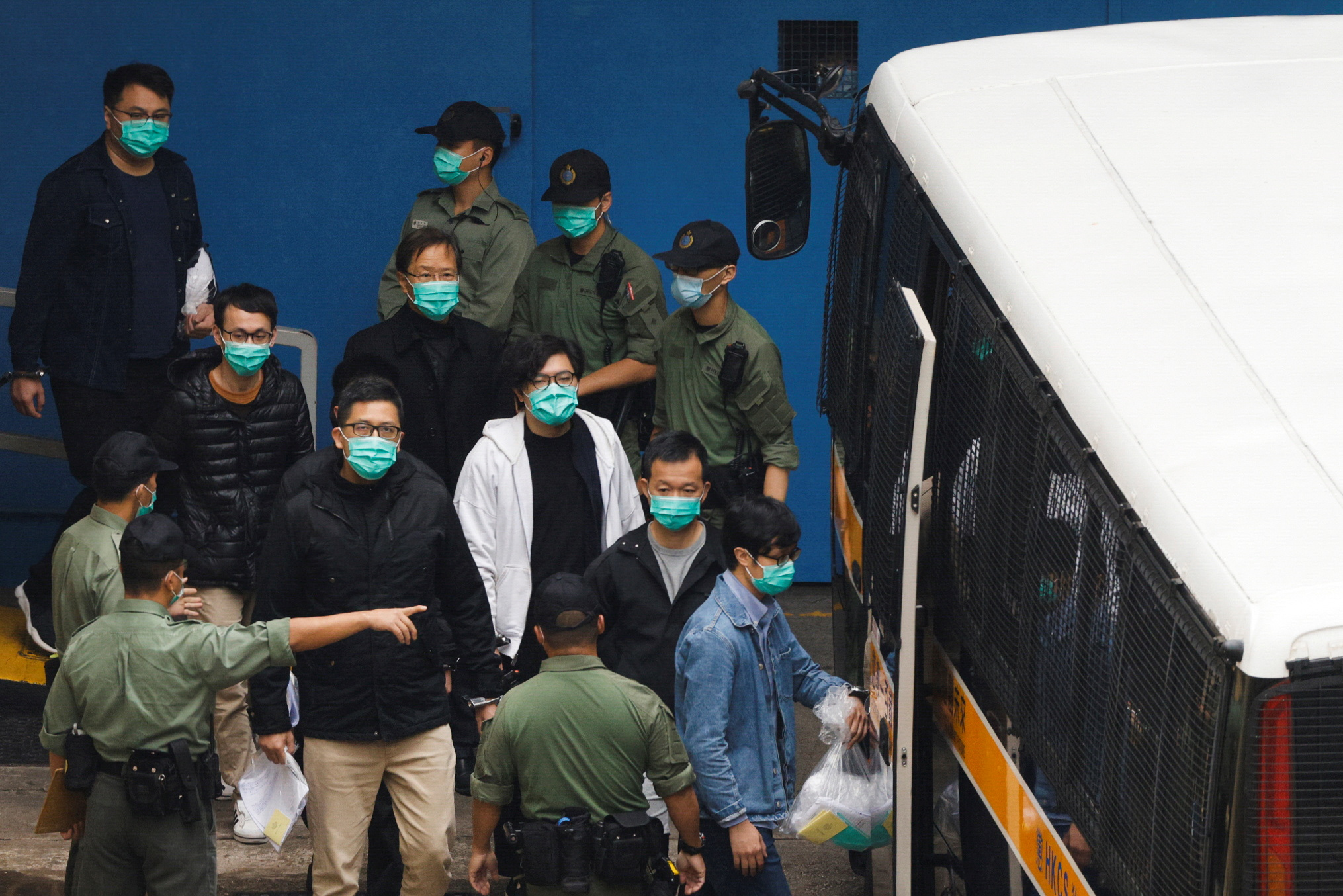 Pro-democracy activists Ventus Lau Wing-hong, Kwok Ka-ki, Lam Cheuk-ting and Raymond Chan Chi-chuen walk to a prison van to head to court with other activists, over a national security law charge, in Hong Kong