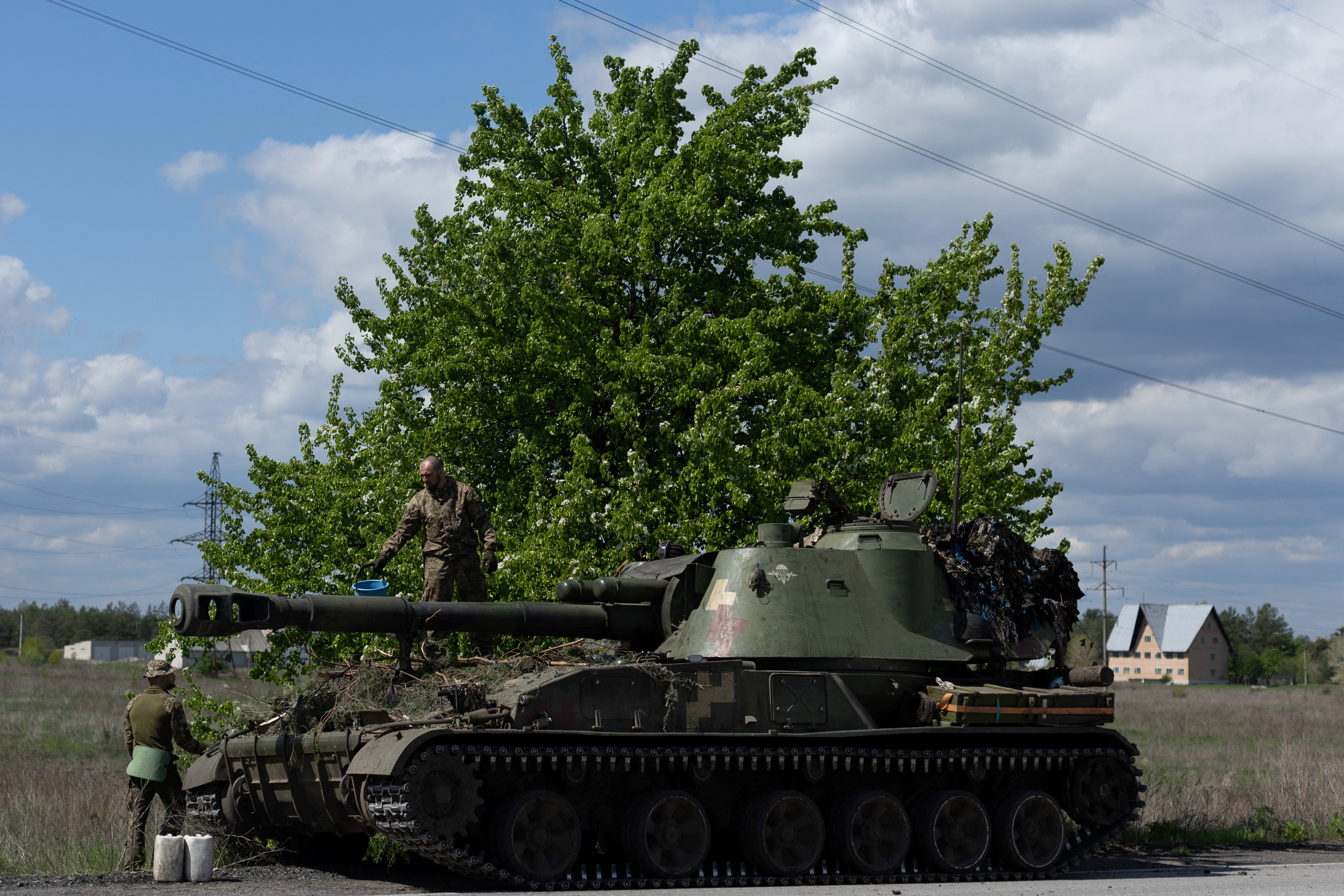 Ukrainian soldiers stand on the top of a tank, amid Russia's invasion of Ukraine, in the frontline city of Lyman, Donetsk region