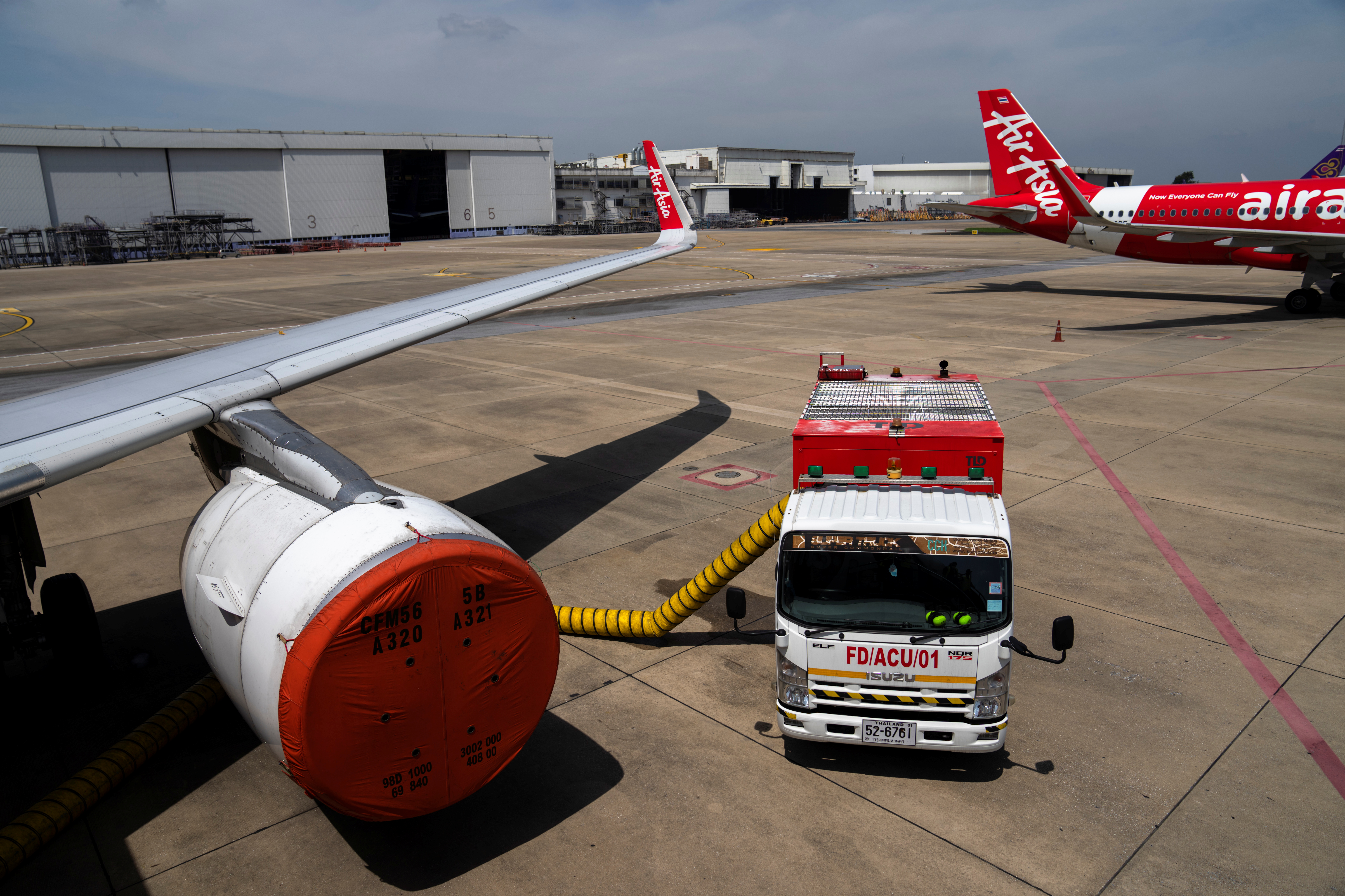 A Thai AirAsia aircraft engine is seen covered, after not being used during the coronavirus disease (COVID-19) pandemic, on the tarmac of Bangkok's Don Muang International Airport, Thailand, October 27, 2021. REUTERS/Athit Perawongmetha