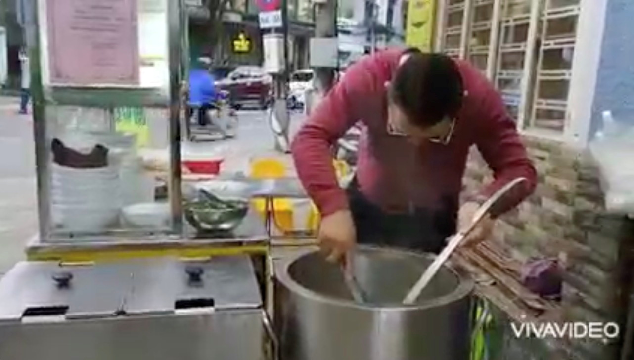 Bui Tuan Lam, 38, cooks at his beef noodle shop, in Danang, Vietnam, November 11, 2021, in this still image obtained from a social media video on November 17, 2021. Bui Tuan Lam/via REUTERS   