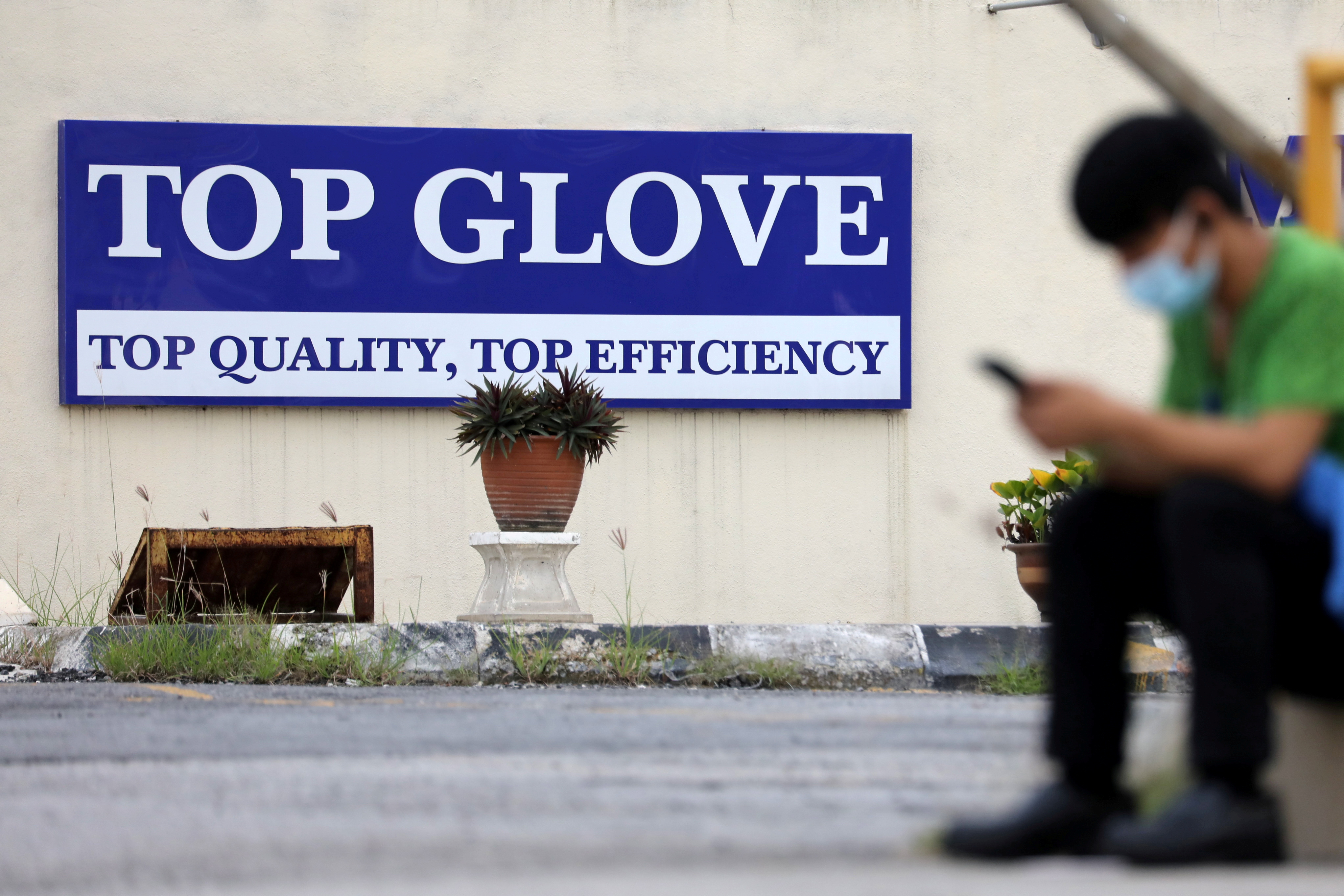 Top Glove logo is pictured outside a factory in Klang