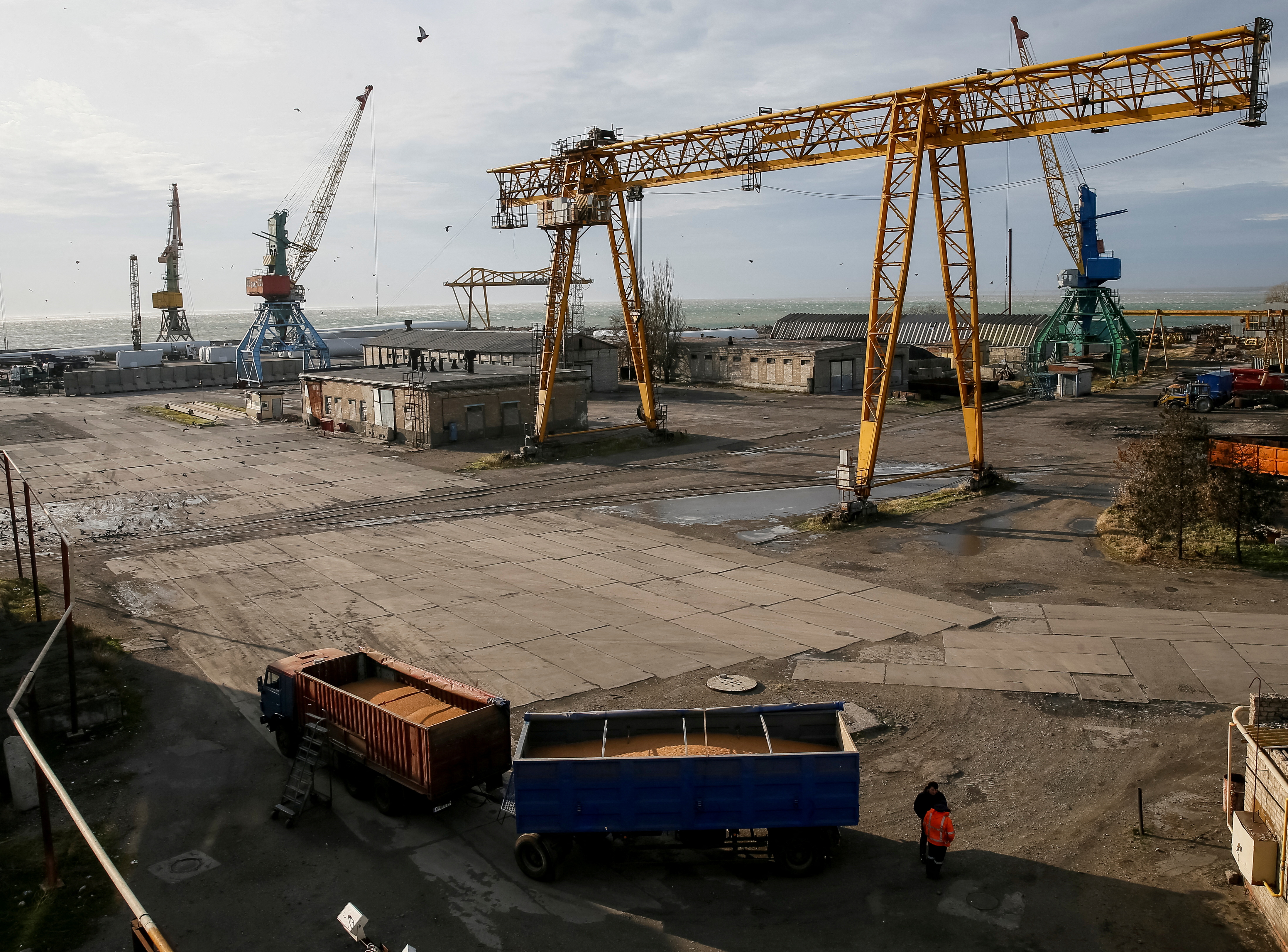 A truck with grain and cranes are seen in the Azov Sea port of Berdyansk