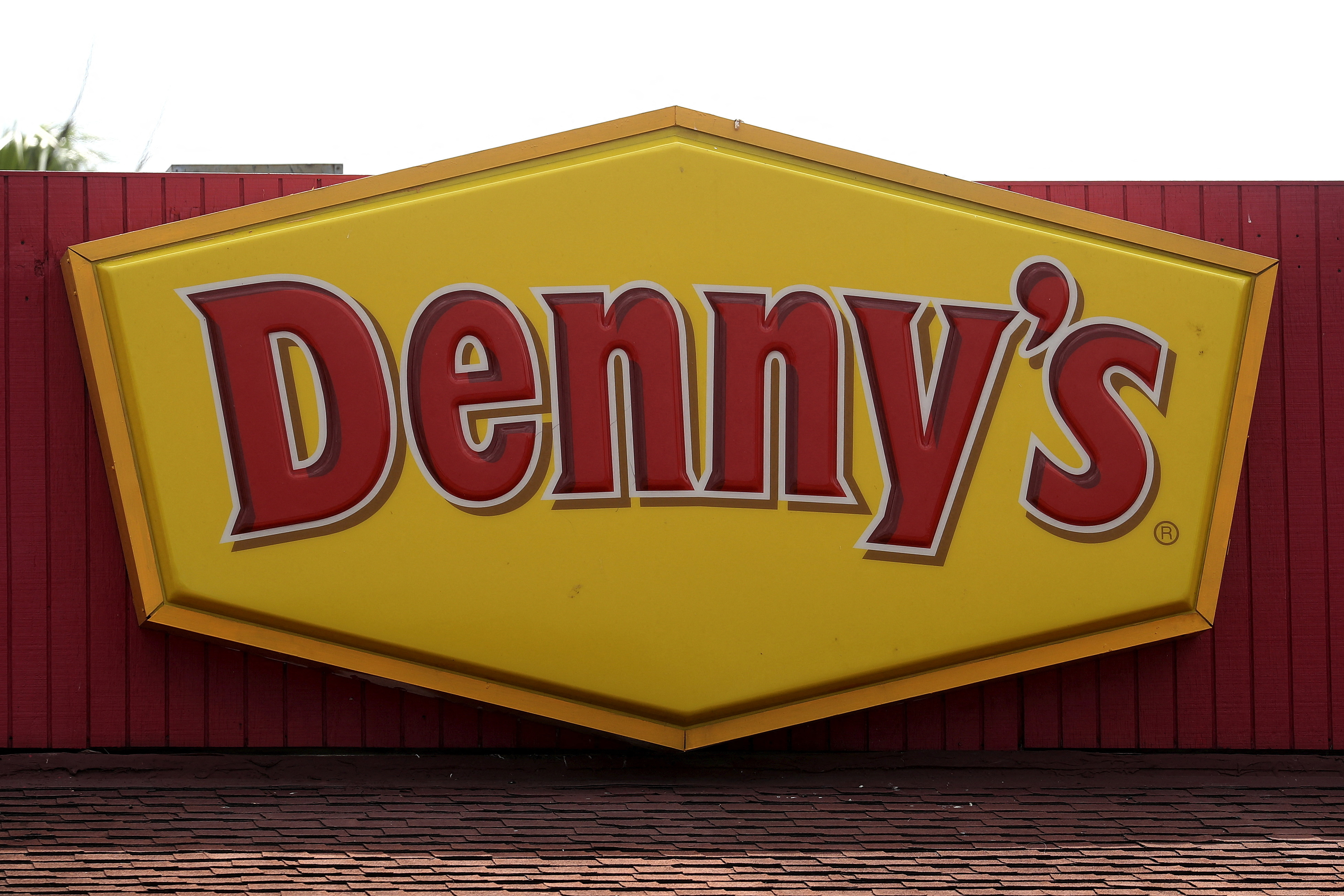 A Denny's restaurant logo is pictured on a building in North Miami, Florida