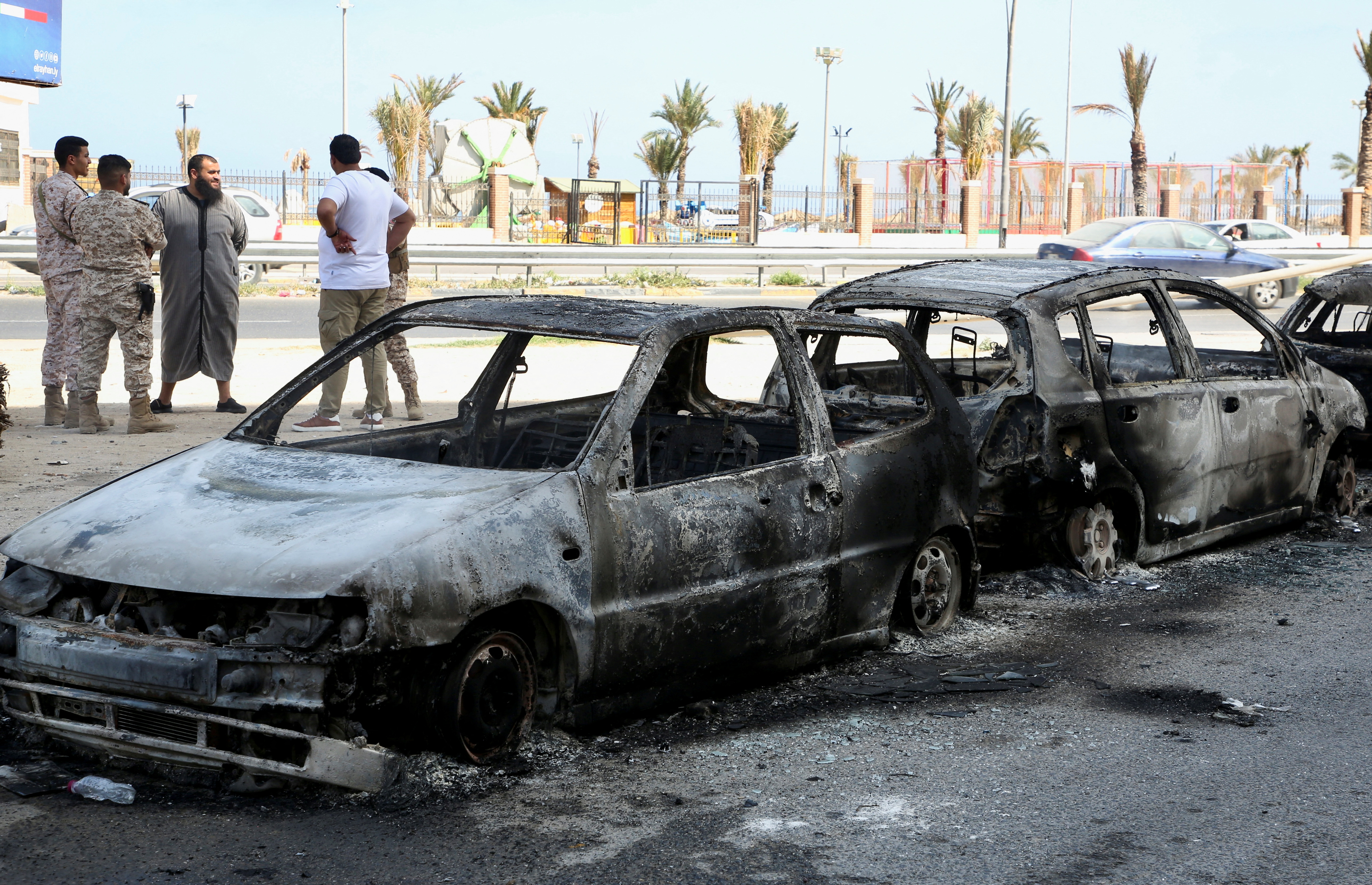 Vehicles destroyed after fighting between soldiers loyal to the head of Libya's Government of National Unity, Abdulhamid al-Dbeibah, and rival forces, are seen in Tripoli