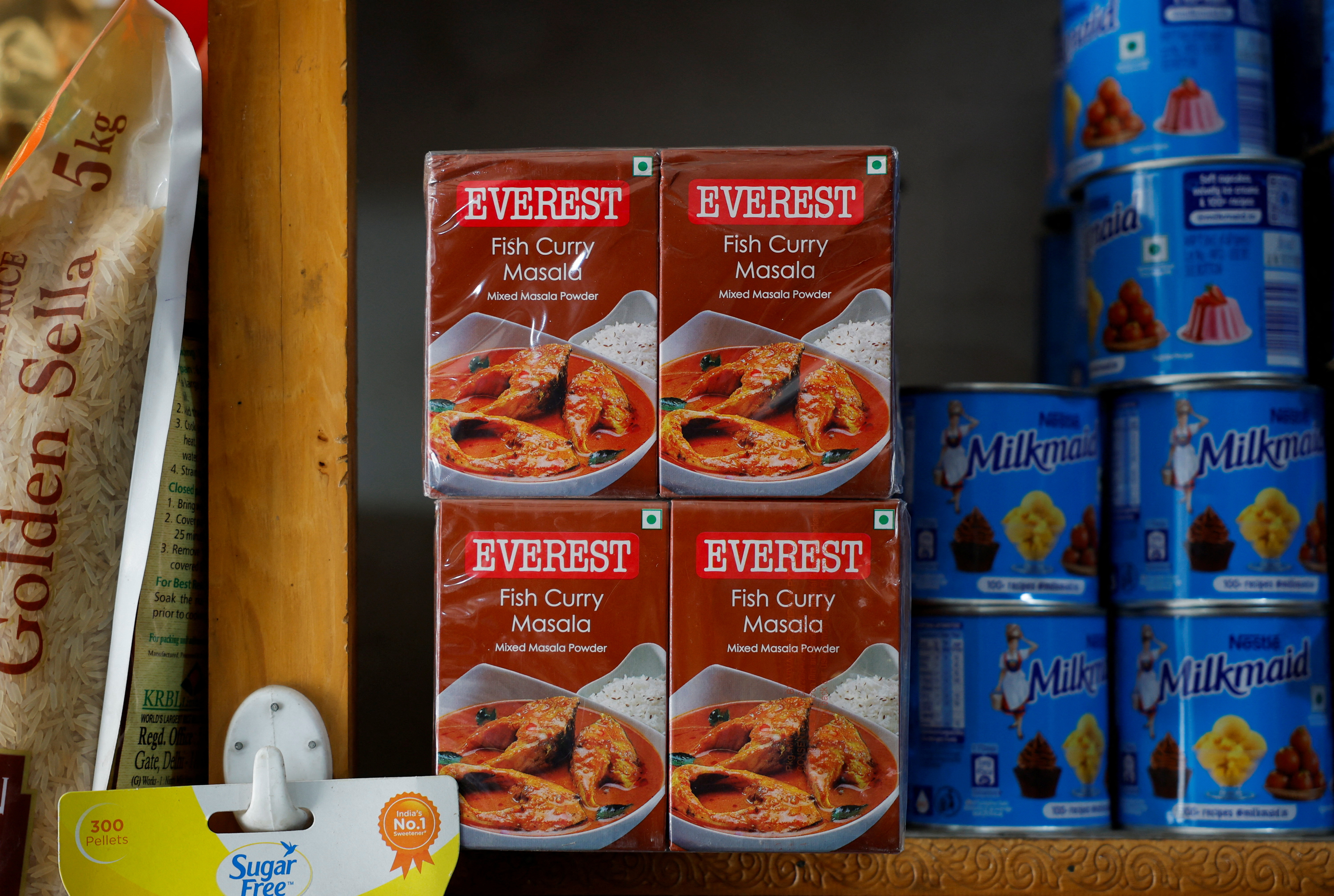 Boxes of Everest fish curry masala are stacked on the shelf of a shop at a market in Srinagar