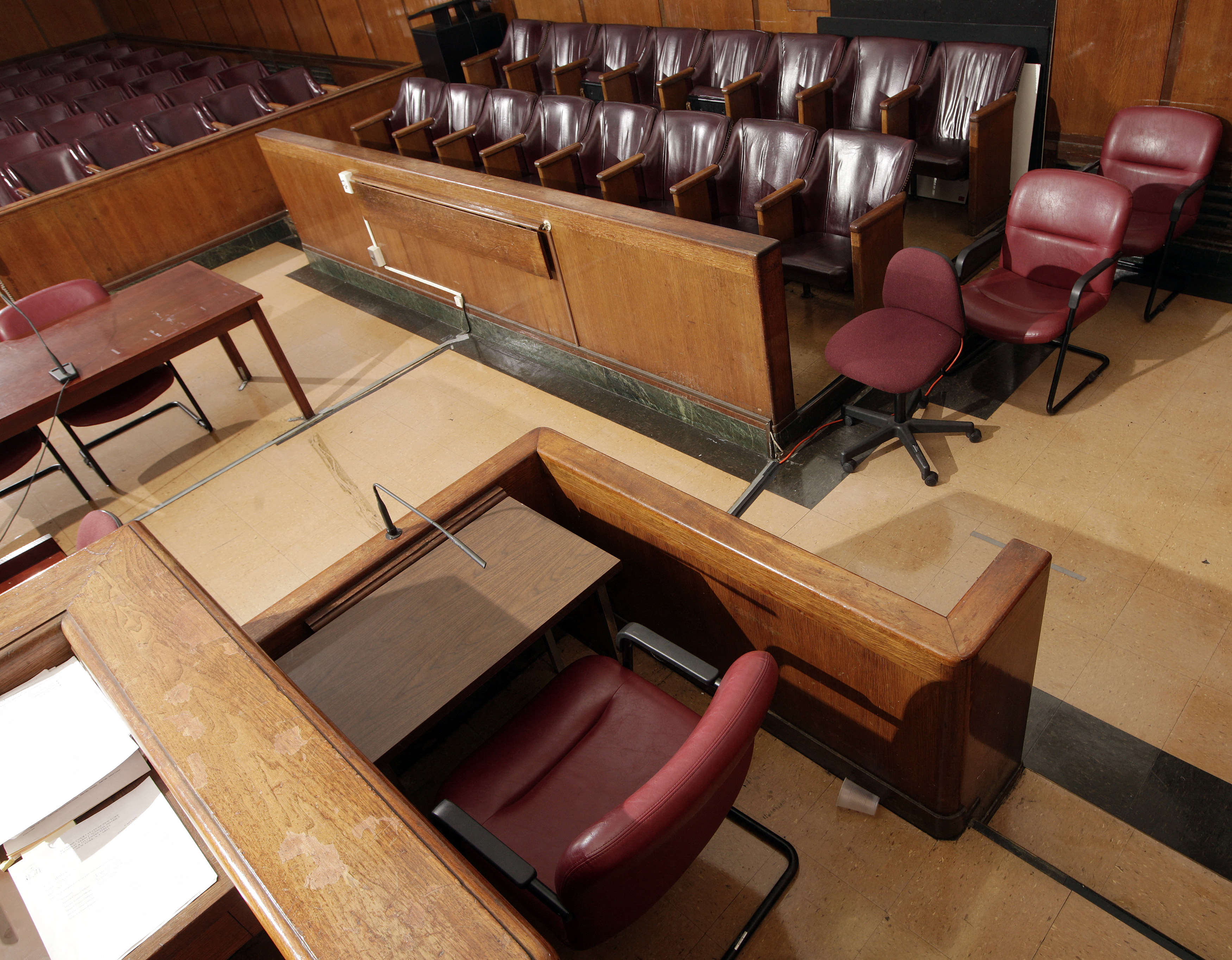 The witness stand (front), jury box (rear R) and the defense table (rear L), in Part 31, Room 1333 of the New York State Supreme Court, Criminal Term at 100 Centre Street, in New York