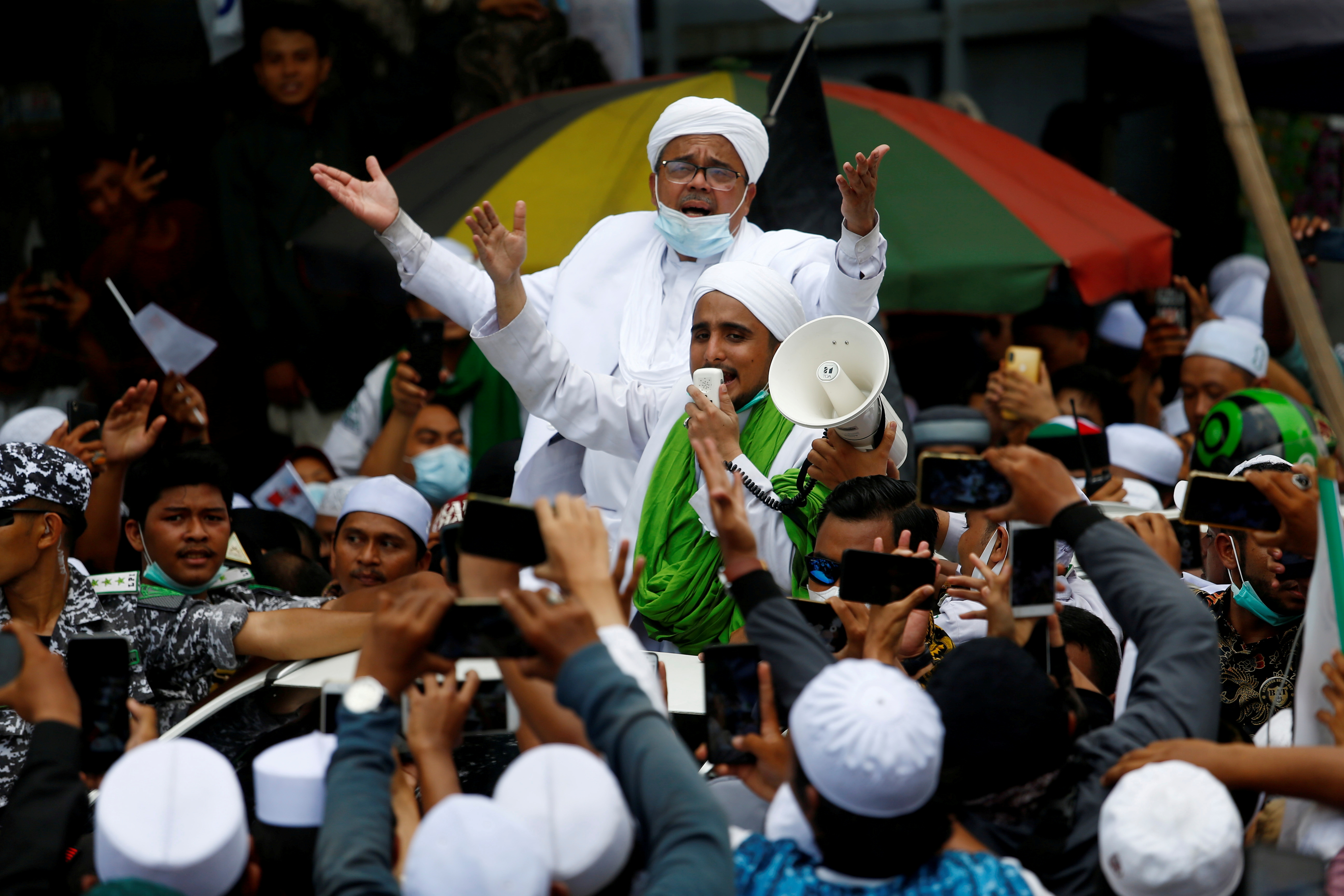 Rizieq Shihab, leader of Indonesian Islamic Defenders Front (FPI), is greeted by supporters at the Tanah Abang