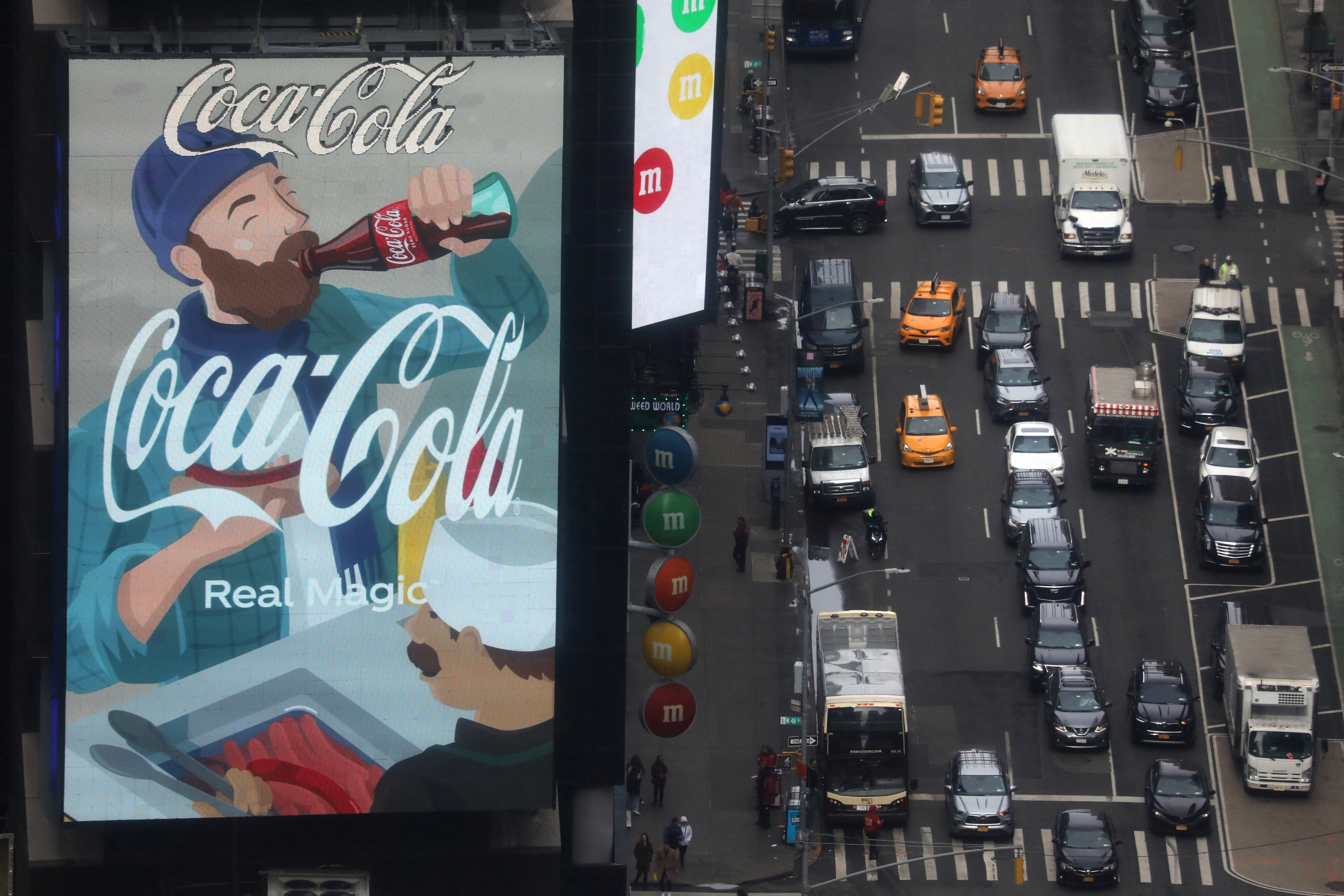 Traffic passes a Coca-Cola digital billboard in the Times Square area of Manhattan