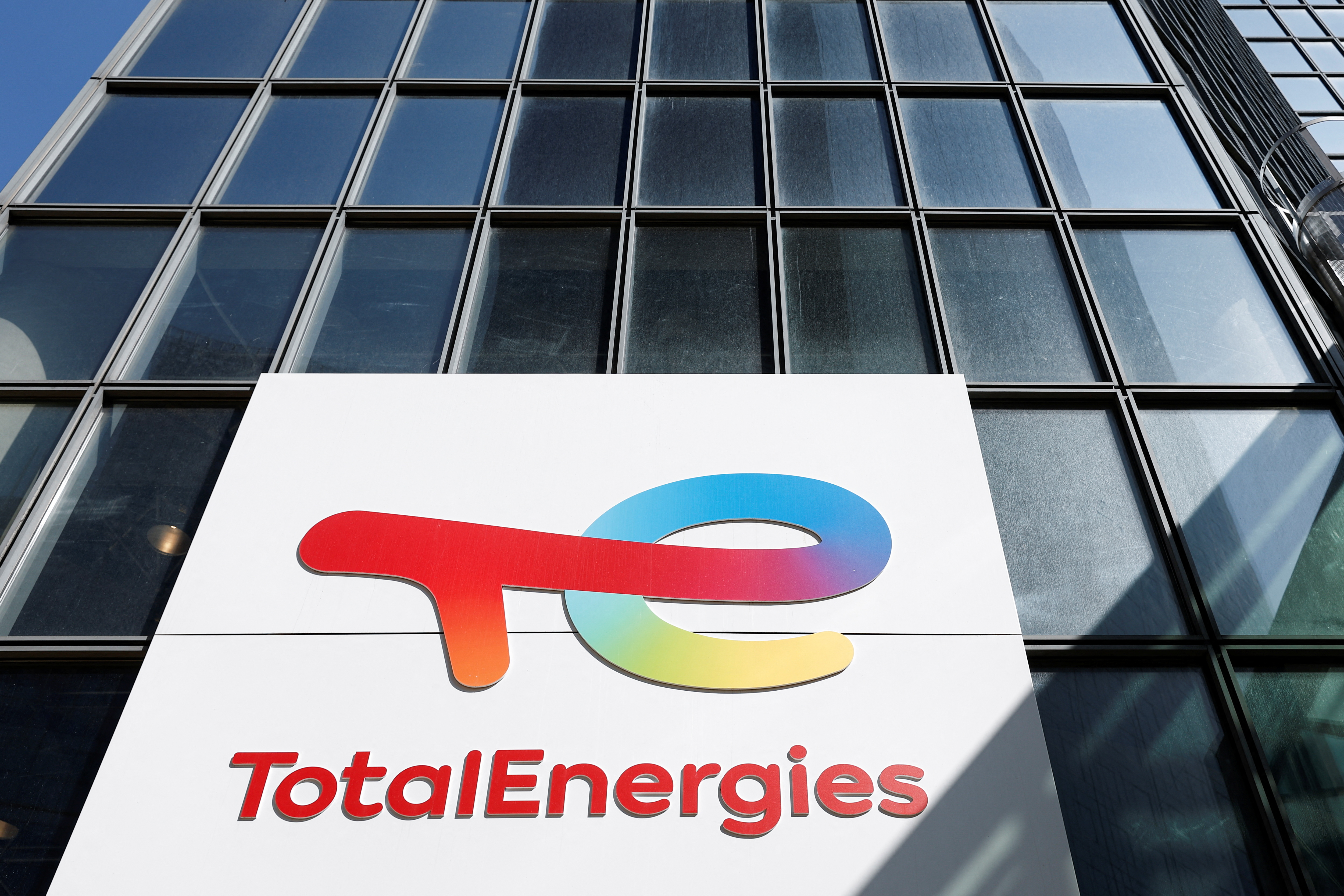The TotalEnergies logo sits on the company's headquarter skyscraper in the La Defense business district in Paris