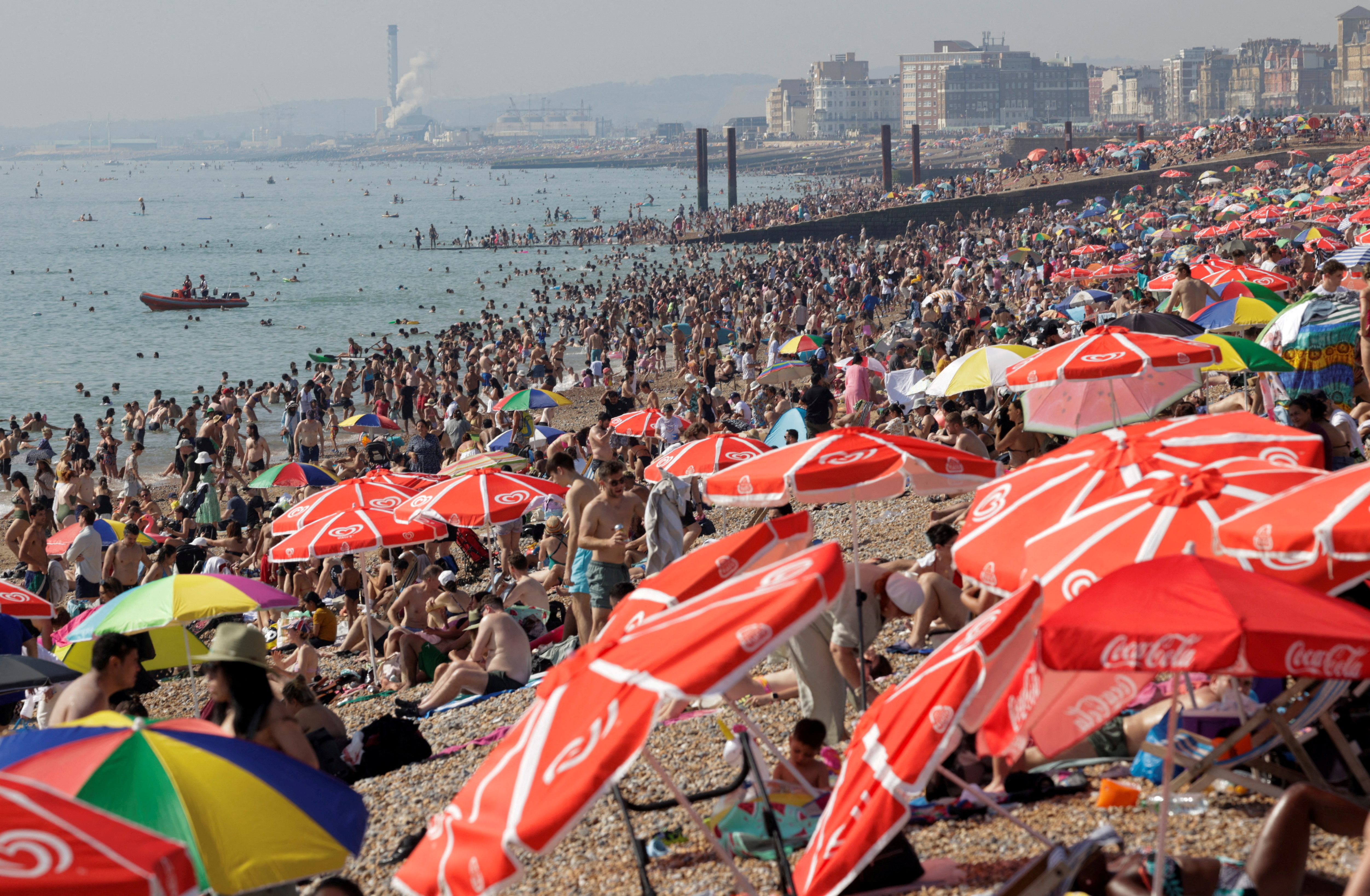 Beachgoers enjoy the hot weather in Brighton