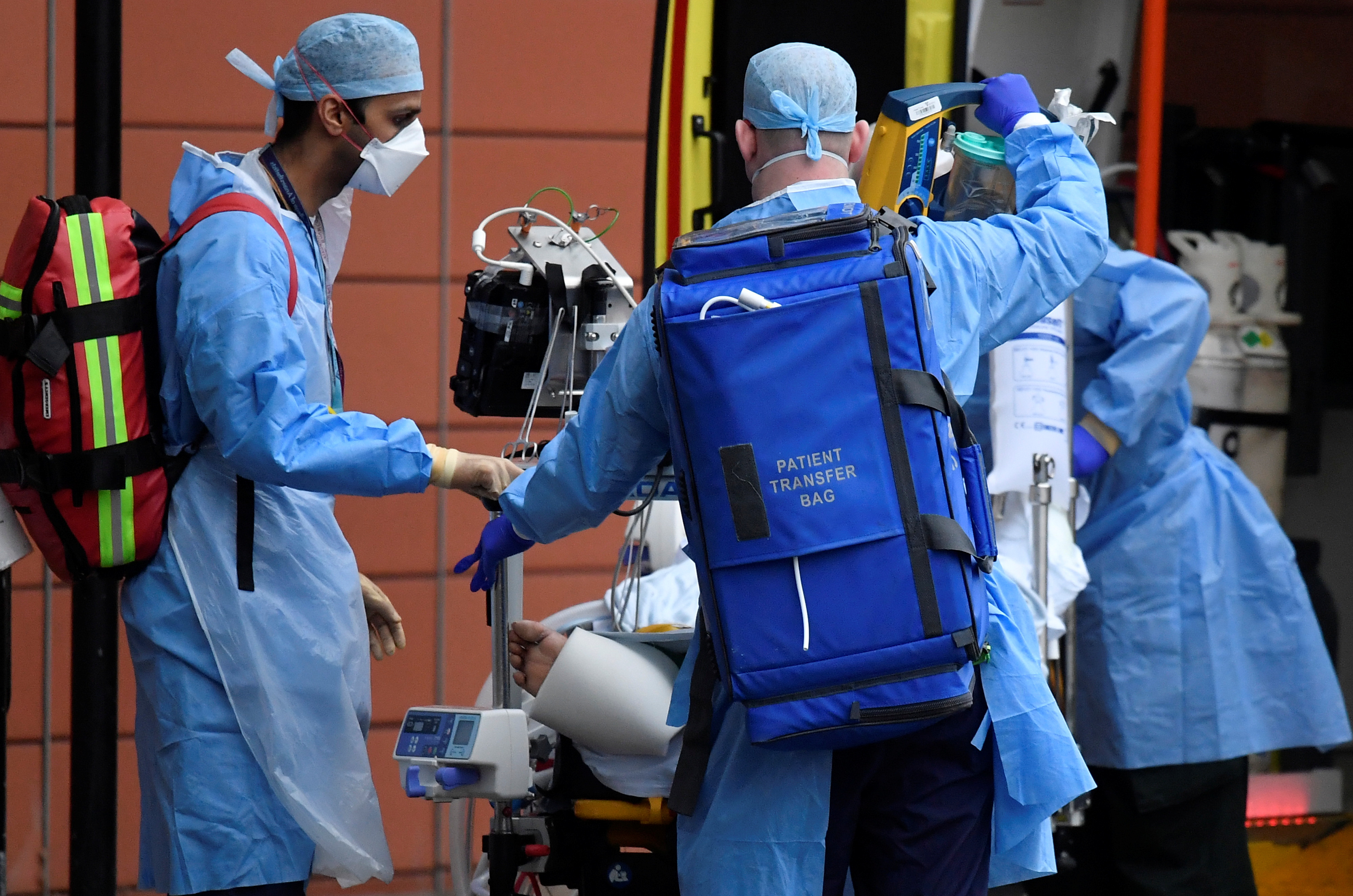 Medical workers move a patient between ambulances outside of the Royal London Hospital amid the spread of the coronavirus disease (COVID-19) pandemic, London, Britain, January 27, 2021. REUTERS/Toby Melville