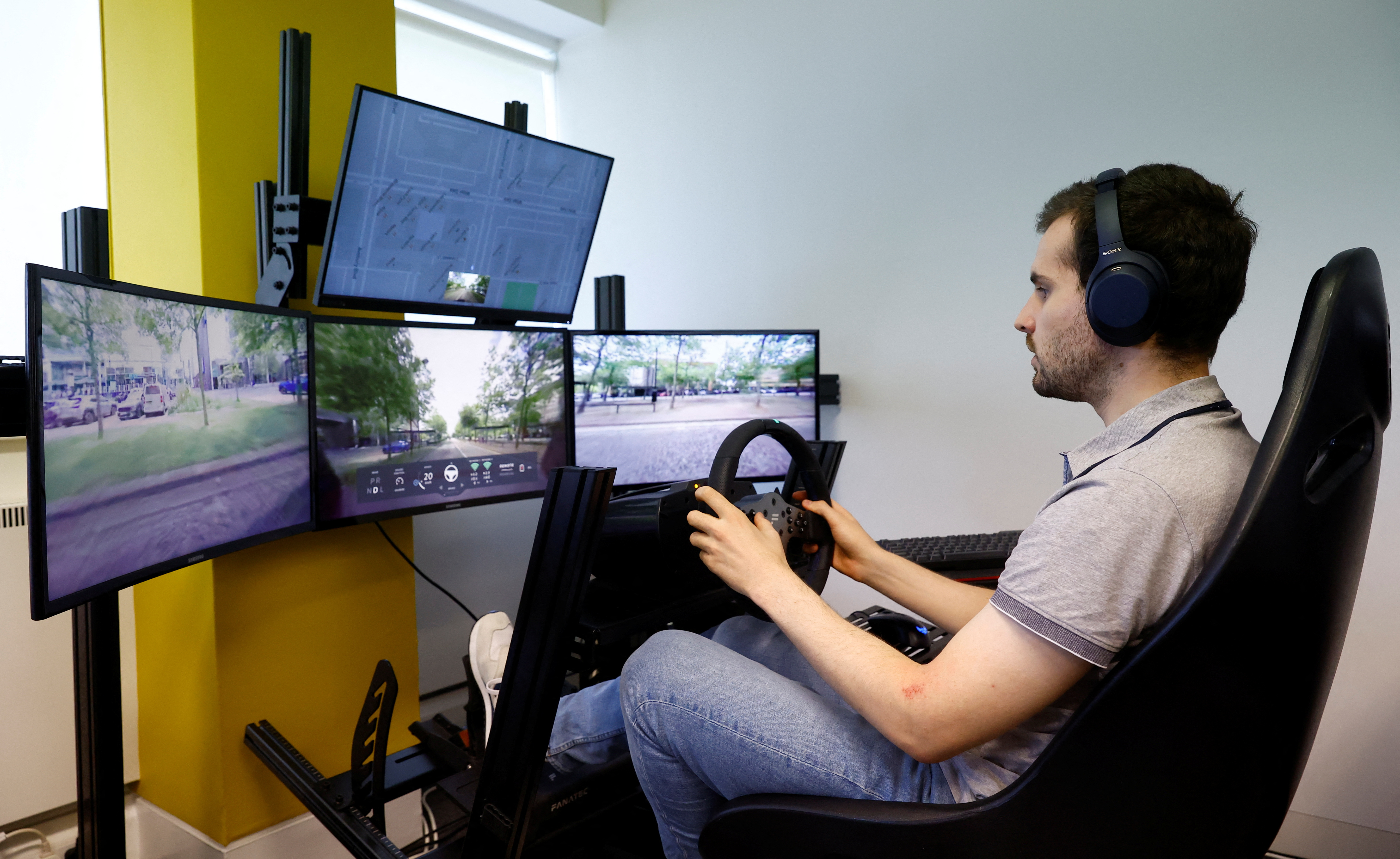 An operator controls a Fetch driverless car during driverless car trials, in Milton Keynes