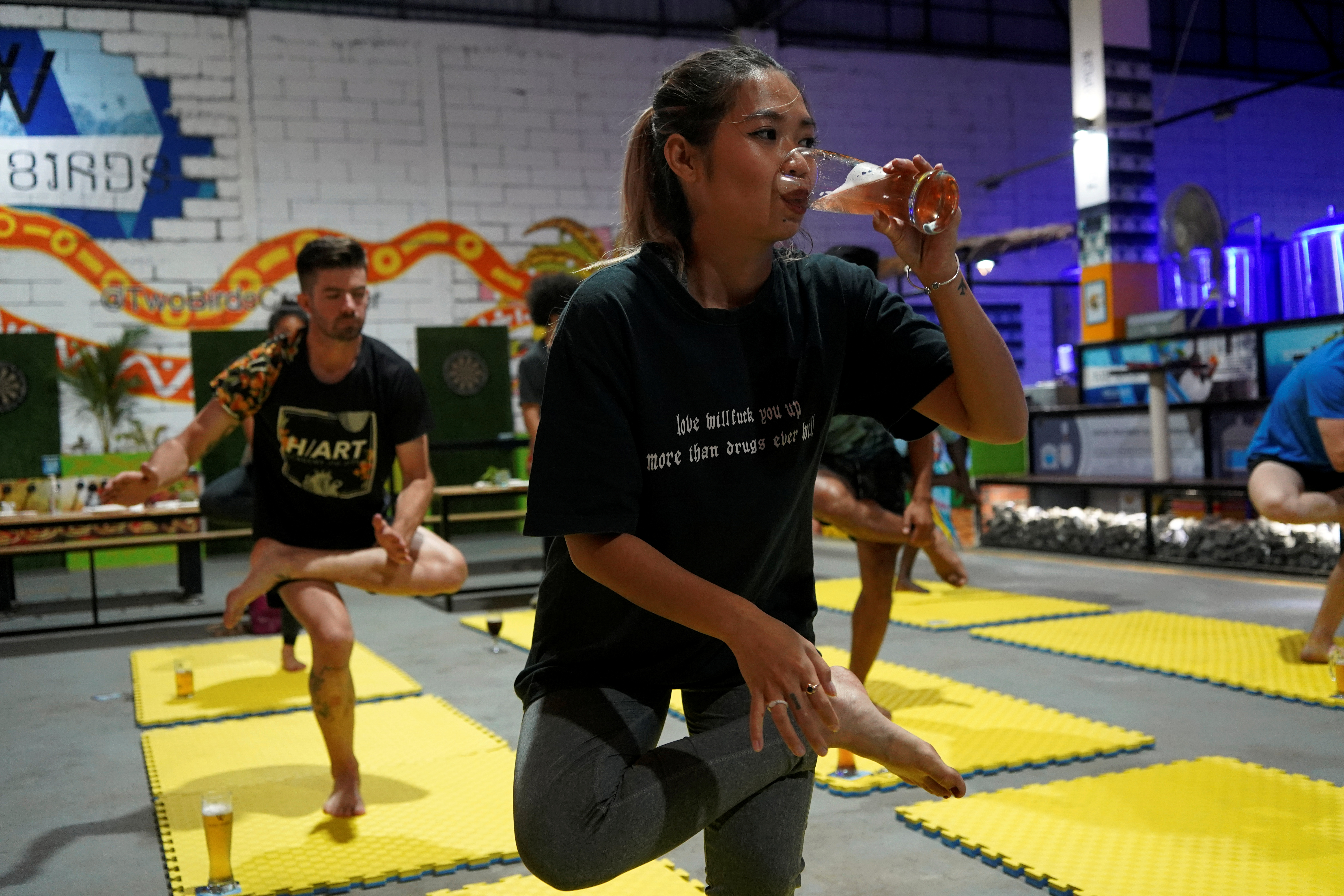 Sreyline Bacha participates in a beer yoga session, as the country eases the coronavirus disease (COVID-19) restrictions, at a craft brewery in Phnom Penh, Cambodia January 19, 2021. Picture taken January 19, 2021. REUTERS/Cindy Liu
