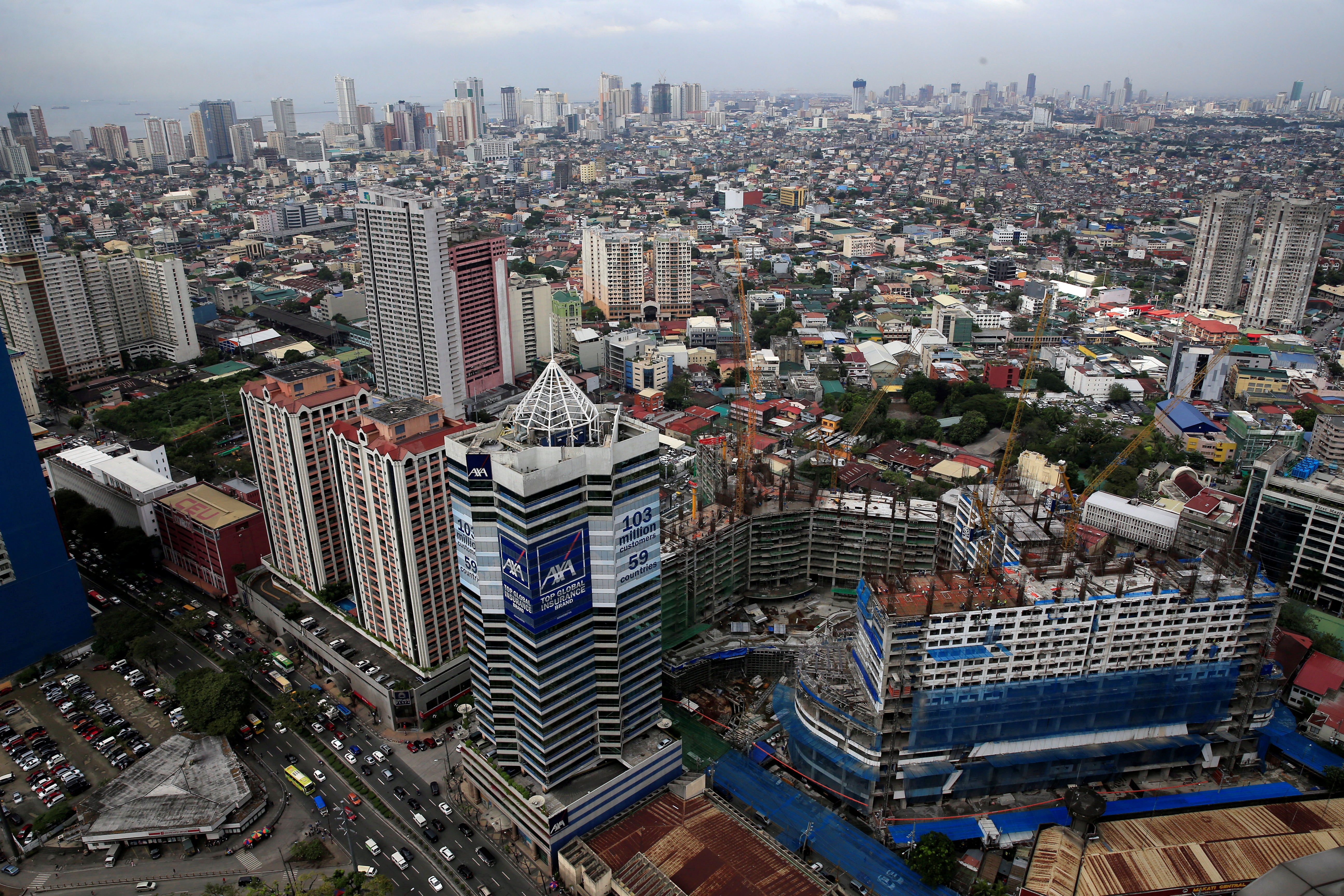 Construction of new buildings alongside older establishments is seen within the business district in Makati City, metro Manila