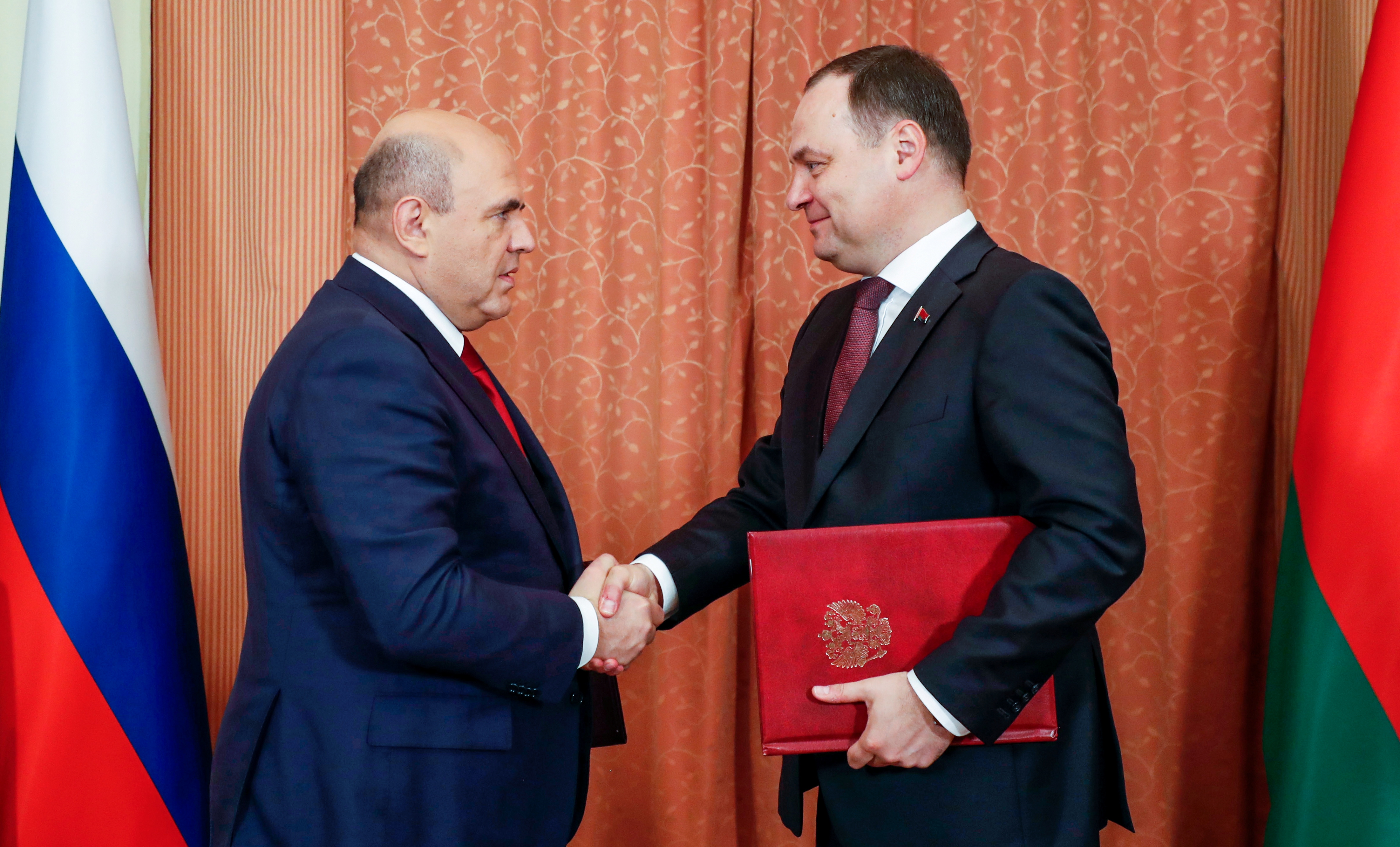 Russian Prime Minister Mishustin and his Belarusian counterpart Roman Golovchenko attend a signing ceremony in Minsk