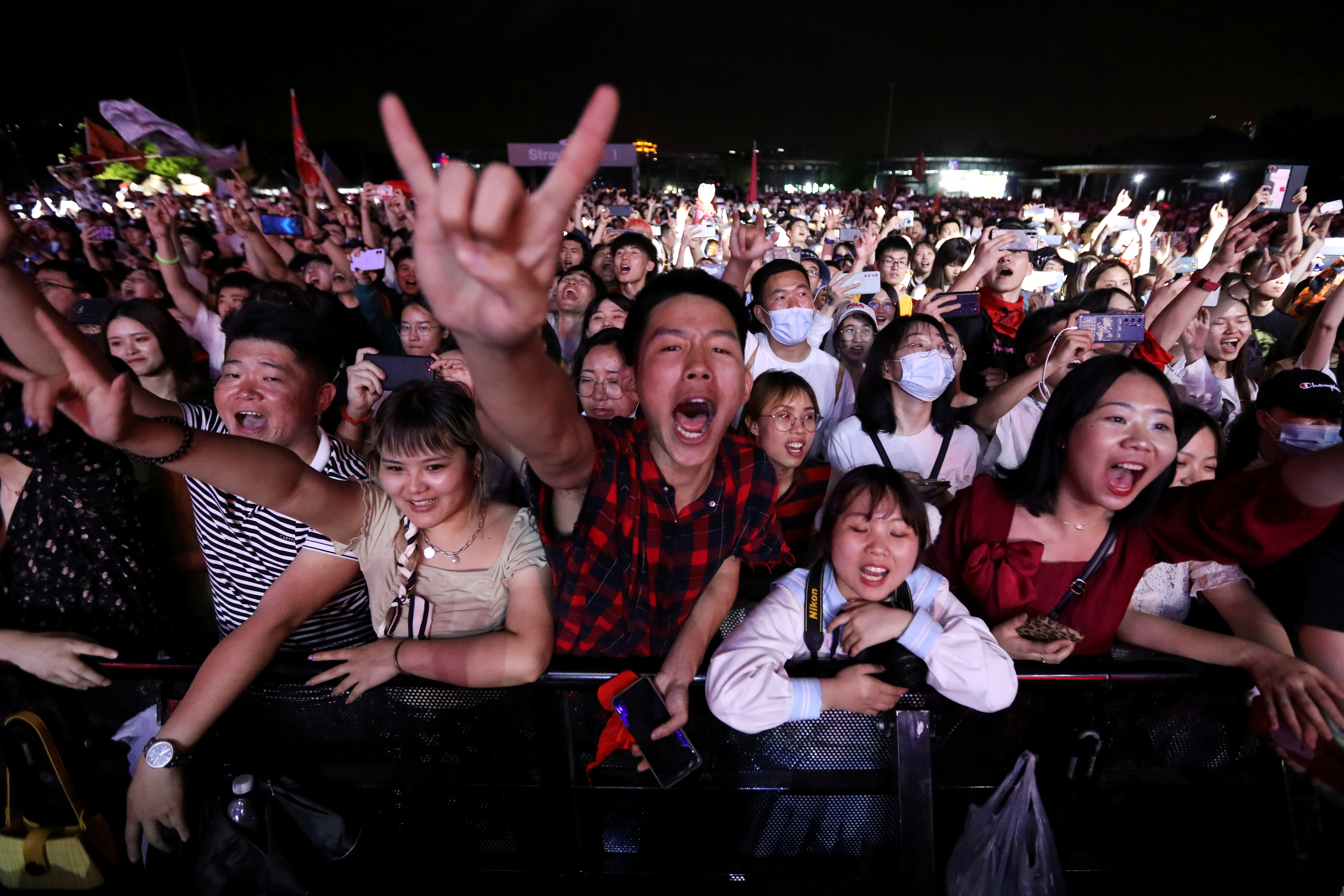 Fans attend a performance of a rock band at the Strawberry Music Festival during Labour Day holiday in Wuhan, Hubei Province, China May 1, 2021. REUTERS/Tingshu Wang TPX IMAGES OF THE DAY