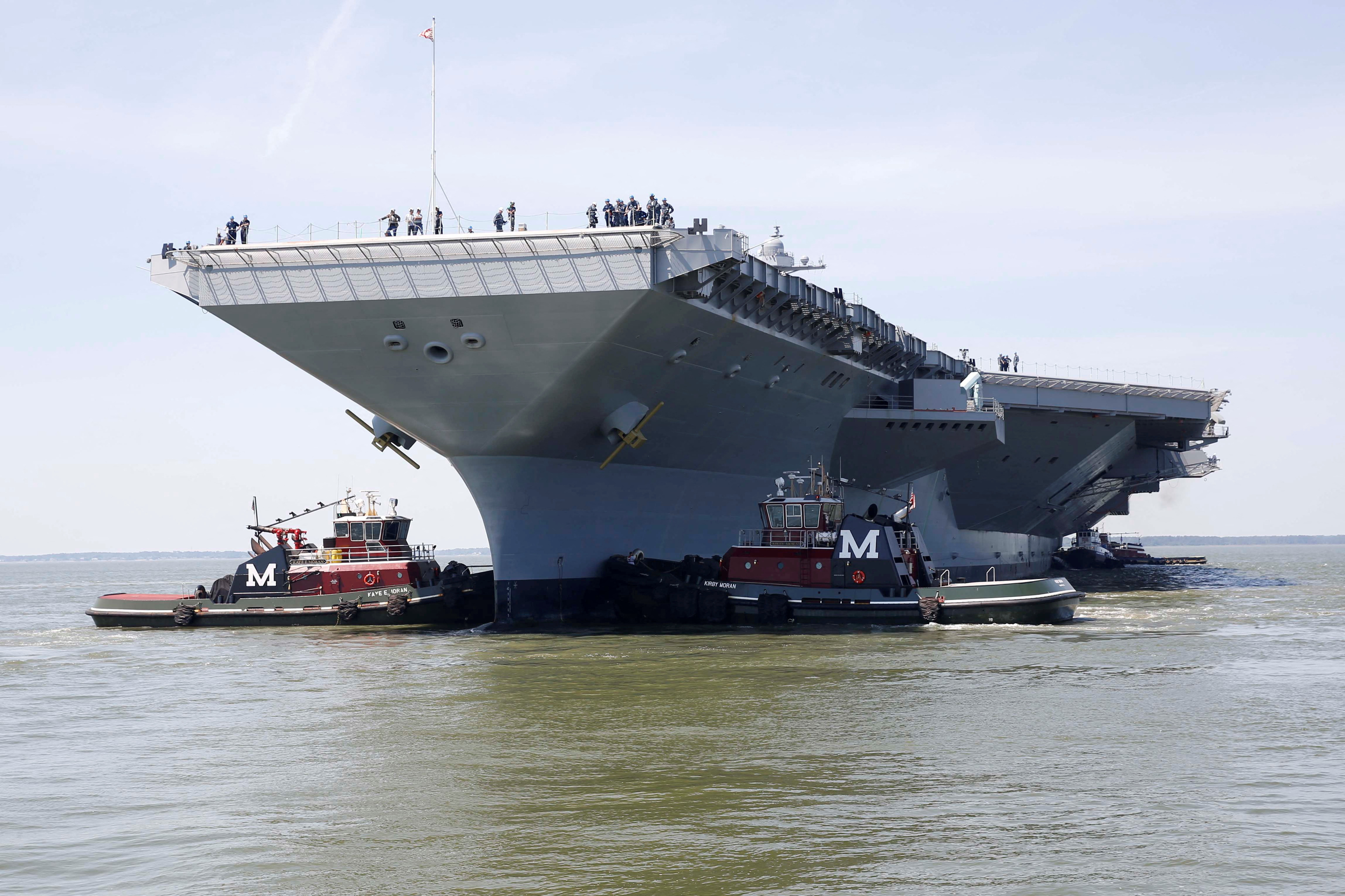 Pre-Commissioning Unit Gerald R. Ford is maneuvered by tug boats in the James River