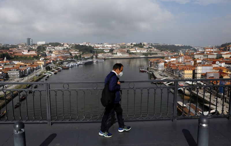 A man walks on the Dom Luis I Bridge in Porto, May 28, 2021.
