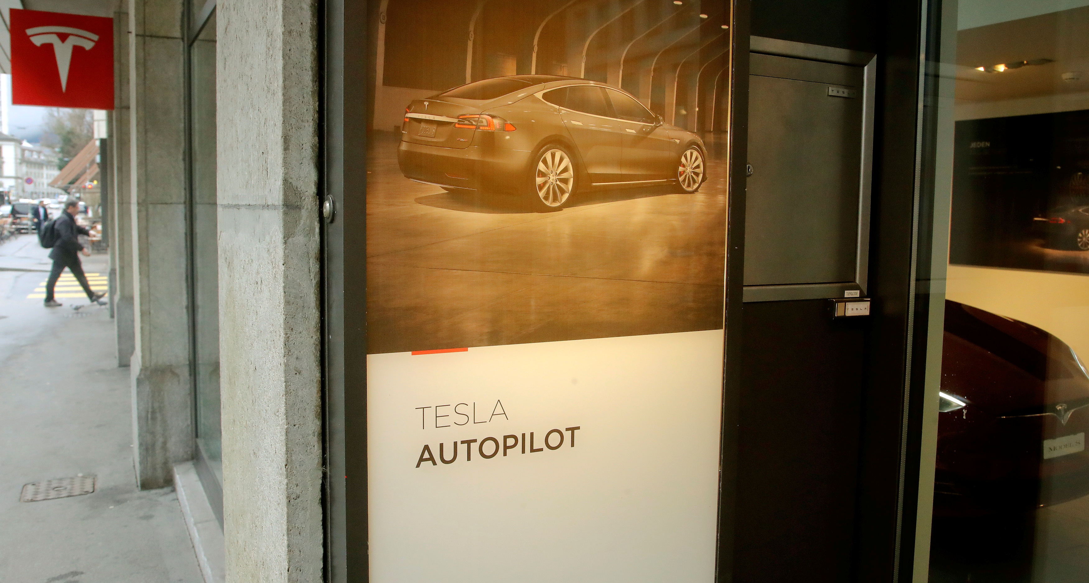 Advertisement promotes Tesla Autopilot at a showroom of U.S. car manufacturer Tesla in Zurich