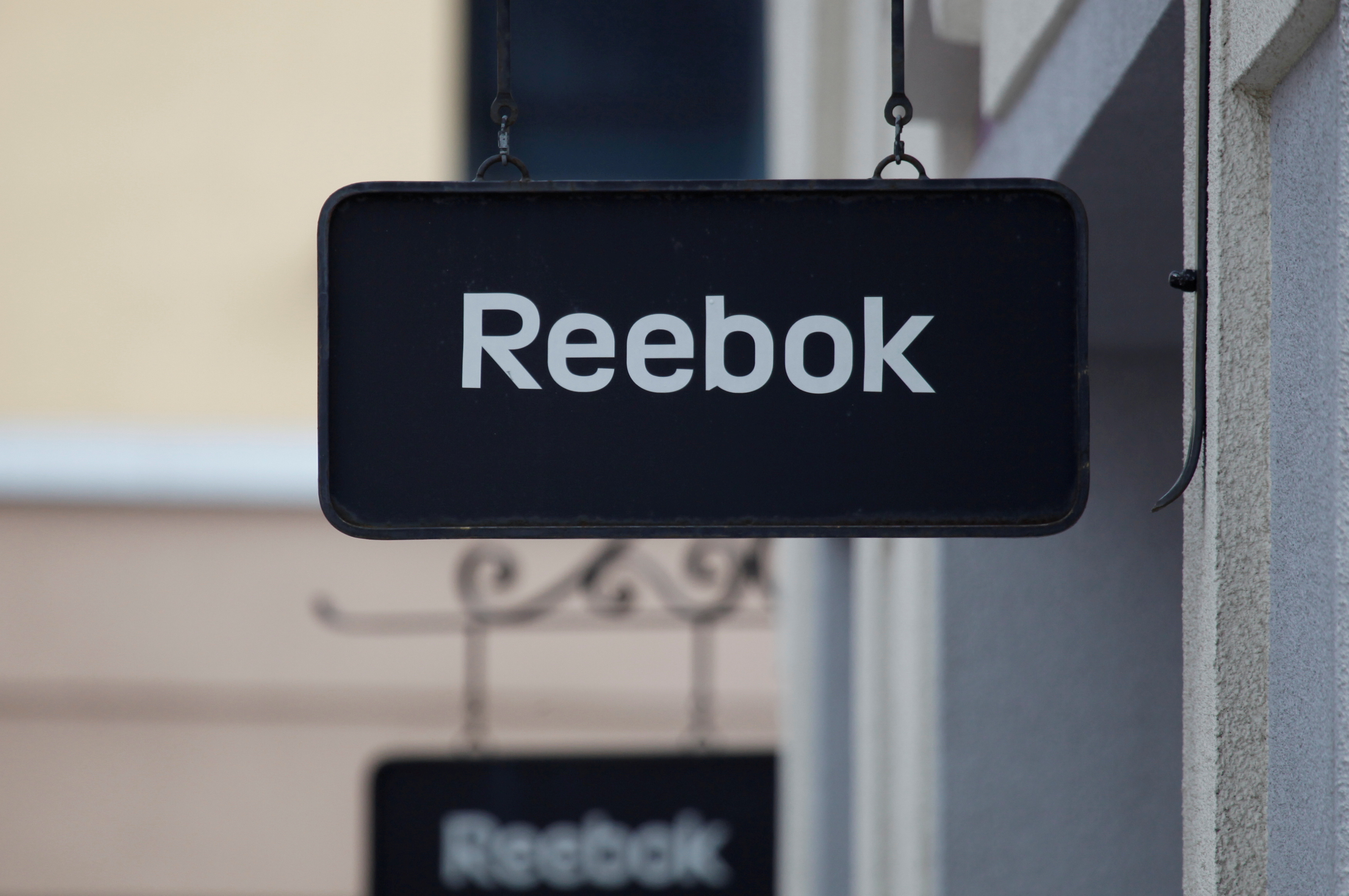 Boards with Reebok store logo are seen on a shopping center at the outlet village Belaya Dacha outside Moscow