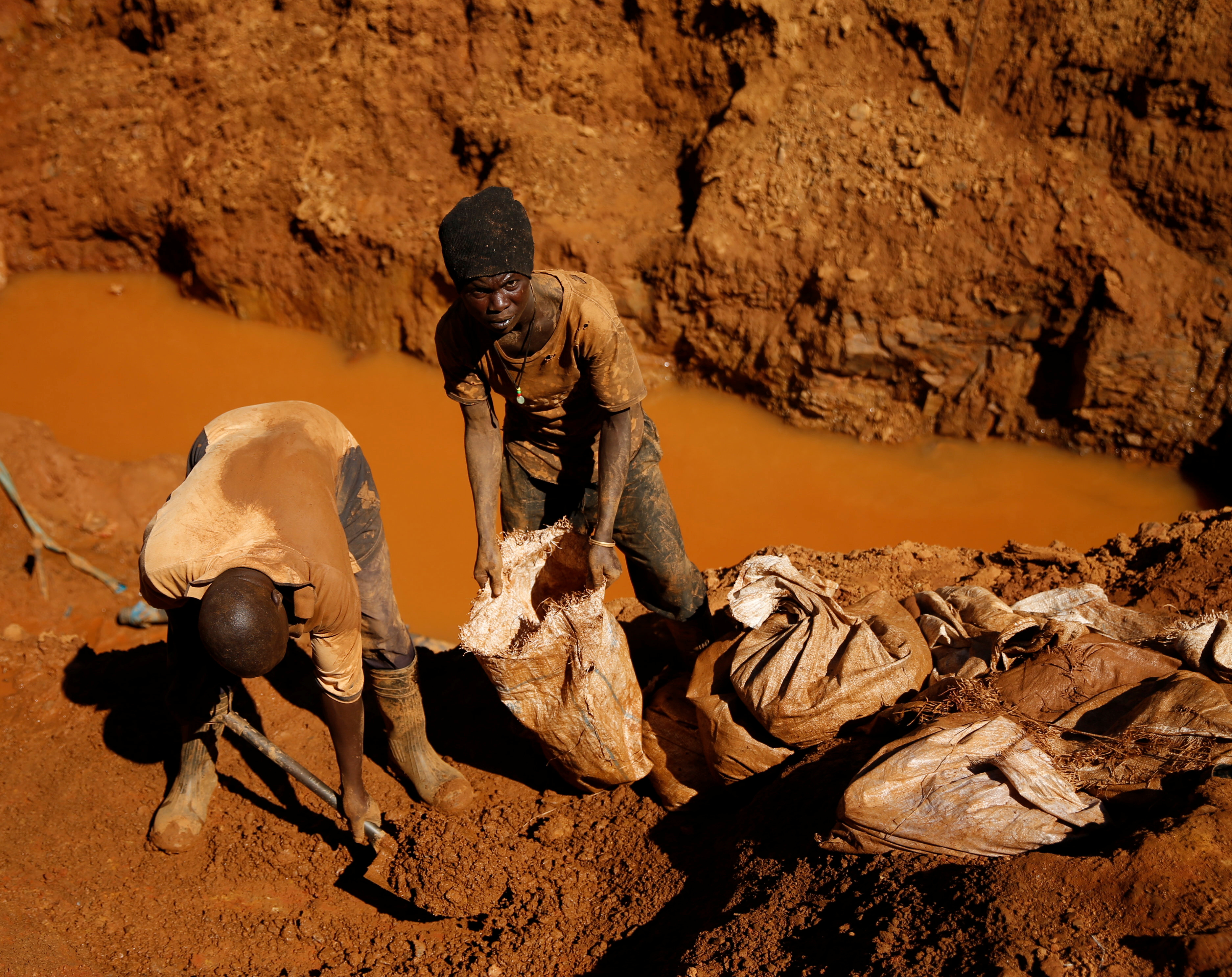 Illegal artisanal gold miners work at an open mine after occupying parts of Smithfield farm, owned by the former President Robert Mugabe's wife Grace Mugabe, in Mazowe