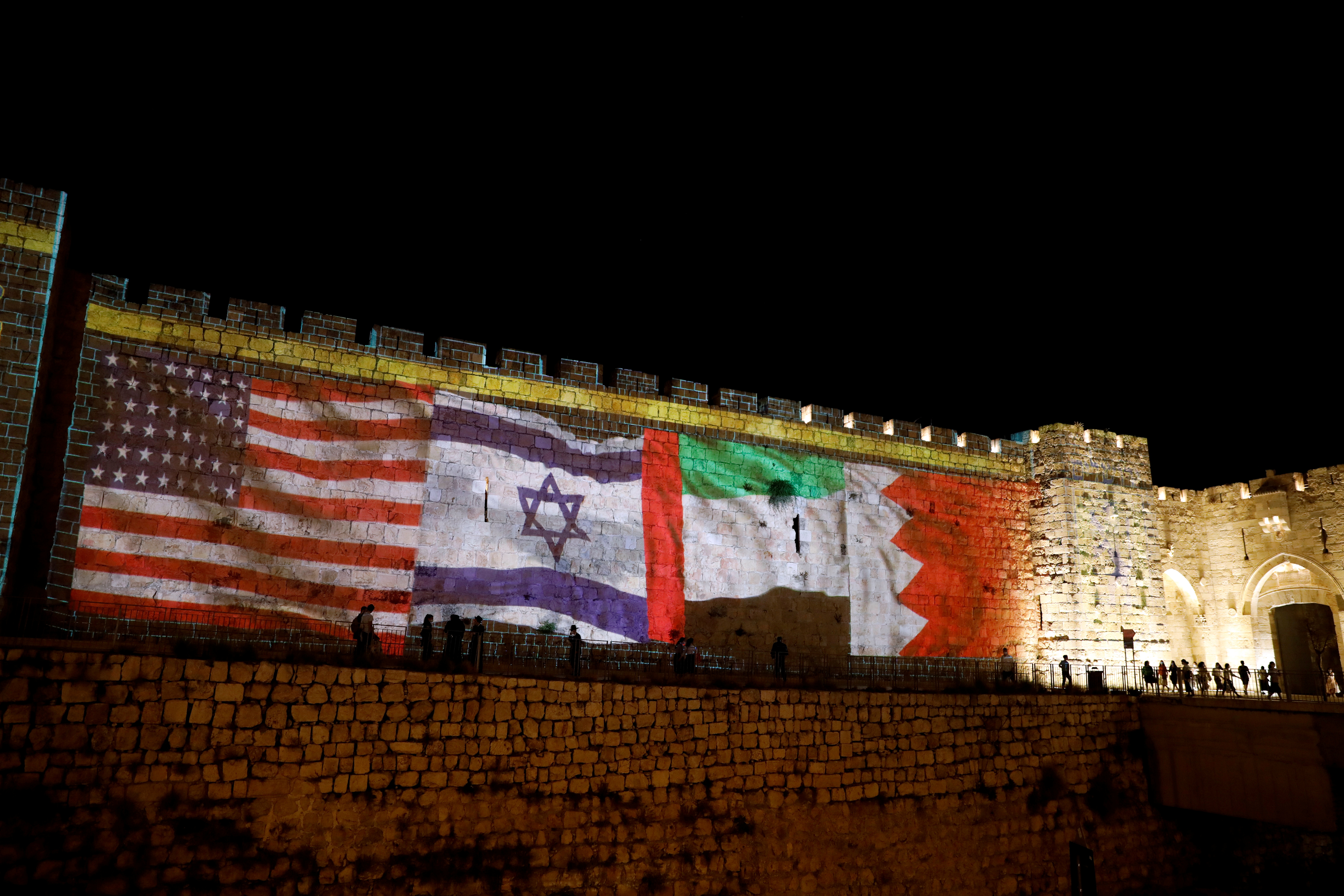 The flags of the United States, Israel, United Arab Emirates and Bahrain are projected on a section of the walls surrounding Jerusalem's Old City, in Jerusalem, September 15, 2020. REUTERS/Ronen Zvulun