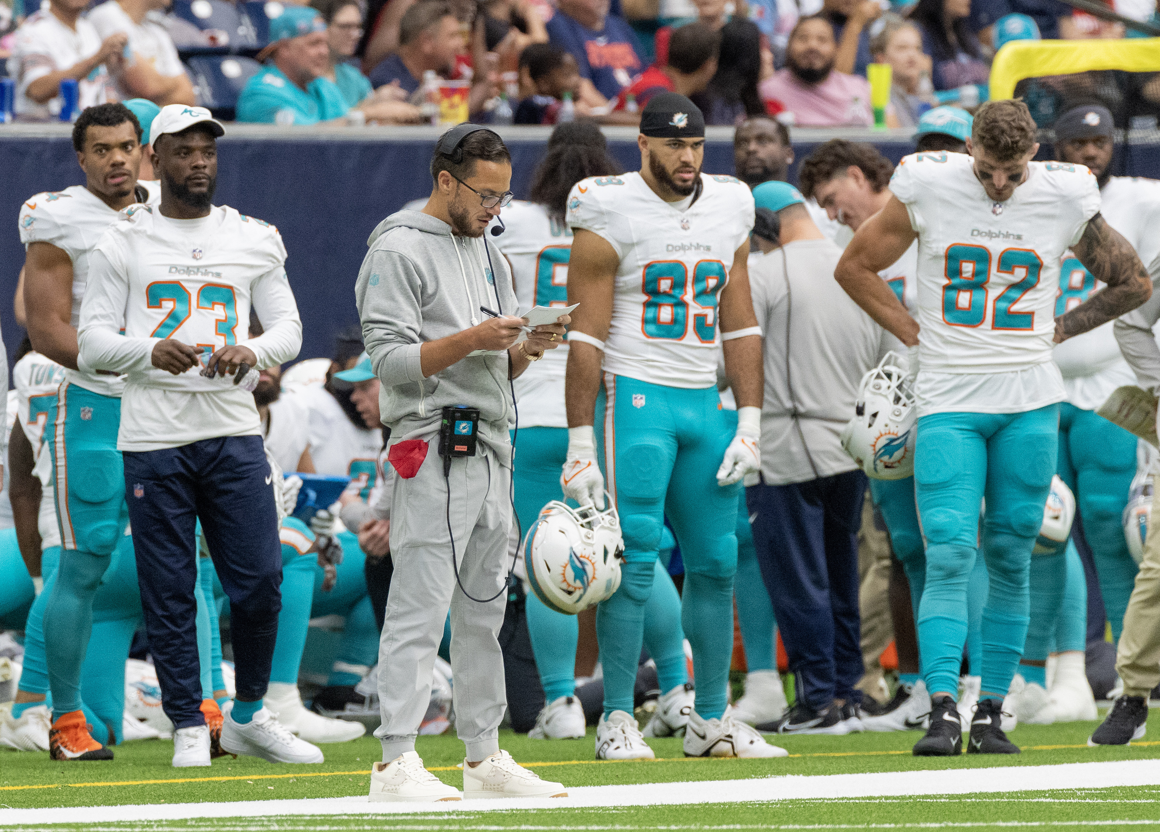 Miami Dolphins quarterback Skylar Thompson (19) and Miami Dolphins  quarterback Tua Tagovailoa (1) talk on the sidelines during an NFL football  game against the Houston Texans, Sunday, Nov. 27, 2022, in Miami