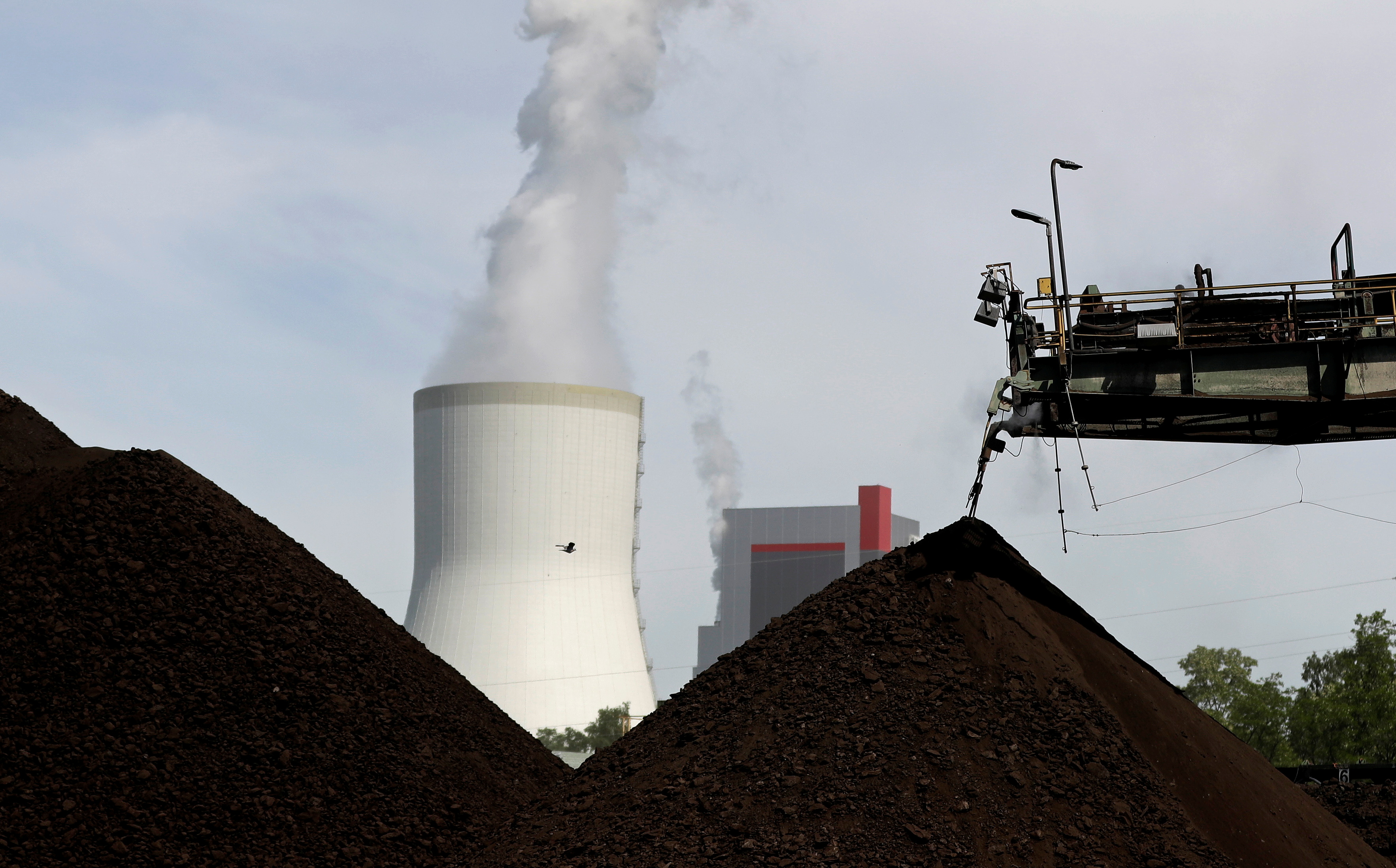 A cooling tower from the Turow coal-fired power plant is seen near the Turow open-pit coal mine operated by the company PGE in Bogatynia