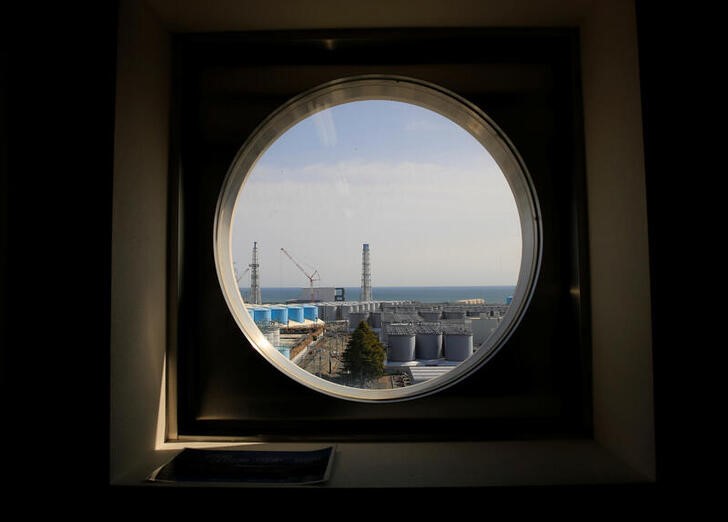 The storage tanks for treated water are seen through a window at the tsunami-crippled Fukushima Daiichi nuclear power plant in Okuma town