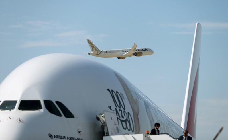 Gulf Air Boeing 787 aircraft makes a fly-by as Emirates Airlines Airbus A380 plane is seen during the Bahrain International Air Show 2018, at Sakhir Air Base