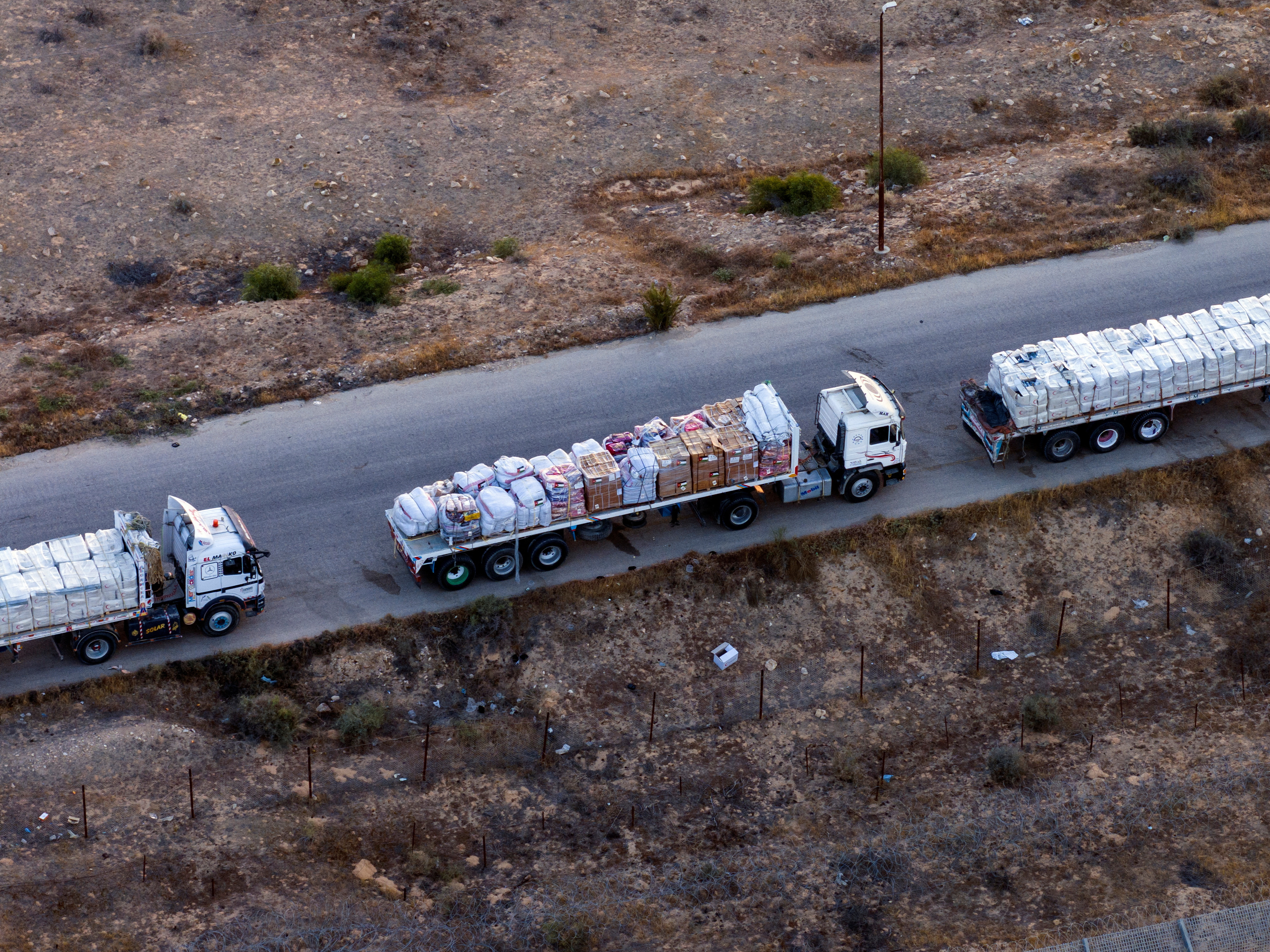 A drone picture of part of a line of trucks waiting on an Egyptian road along the border with Israel, near the Rafah border crossing with the Gaza Strip