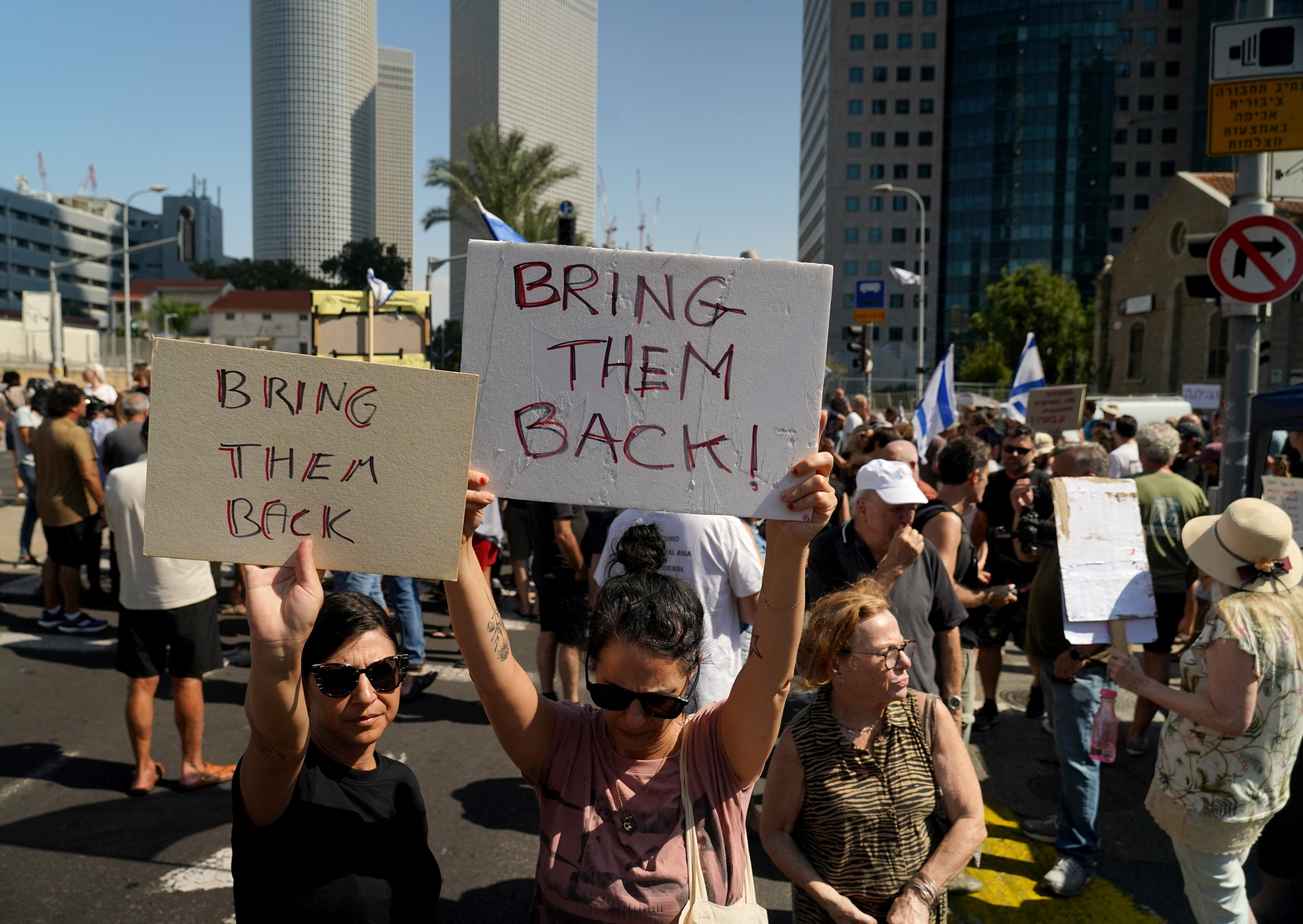 Israelis attend a demonstration, calling for the return of loved ones who were taken as hostages following a deadly infiltration by Hamas gunmen from the Gaza Strip, in Tel Aviv