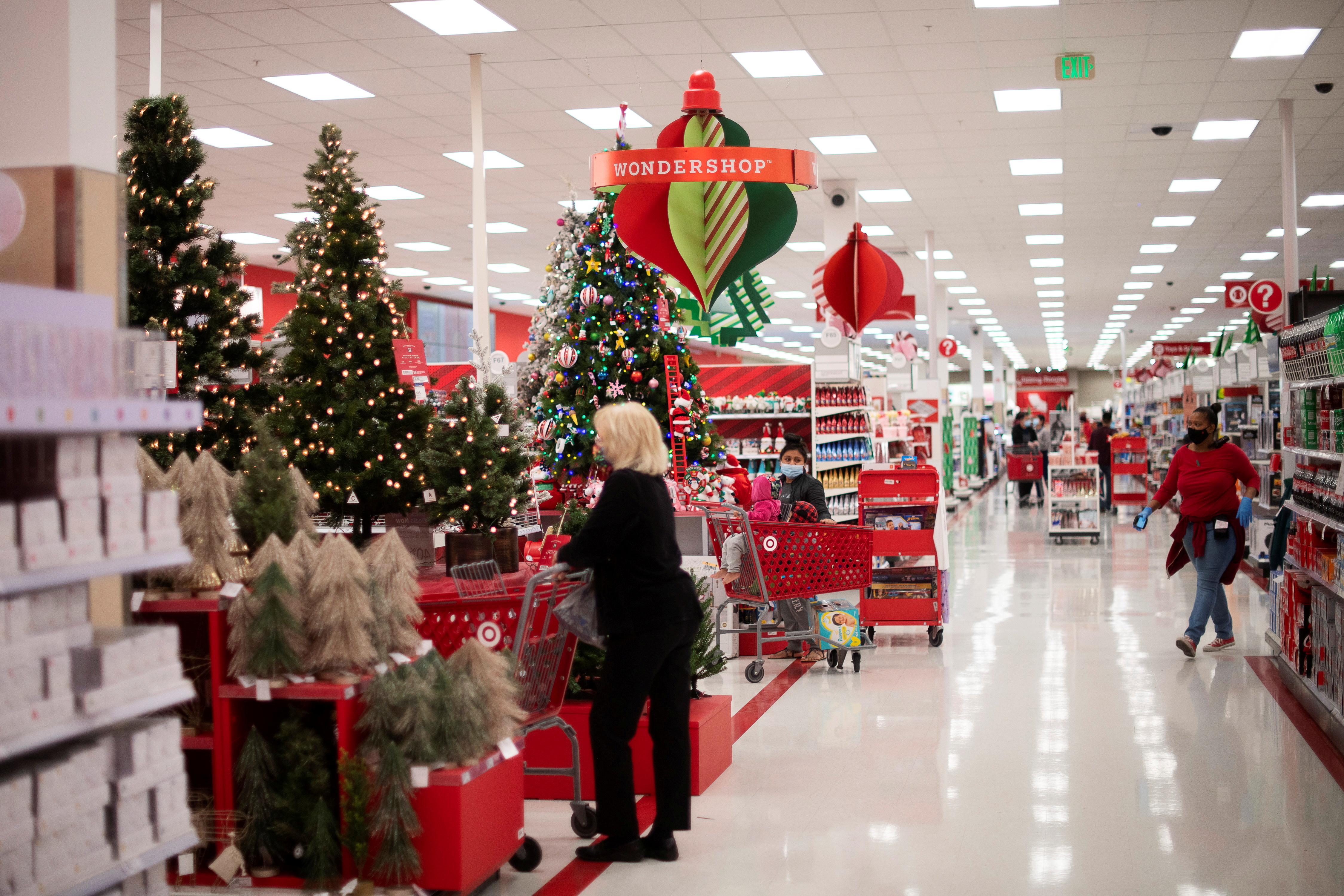 Shoppers browse merchandise beside a Christmas tree display at a Target store in King of Prussia