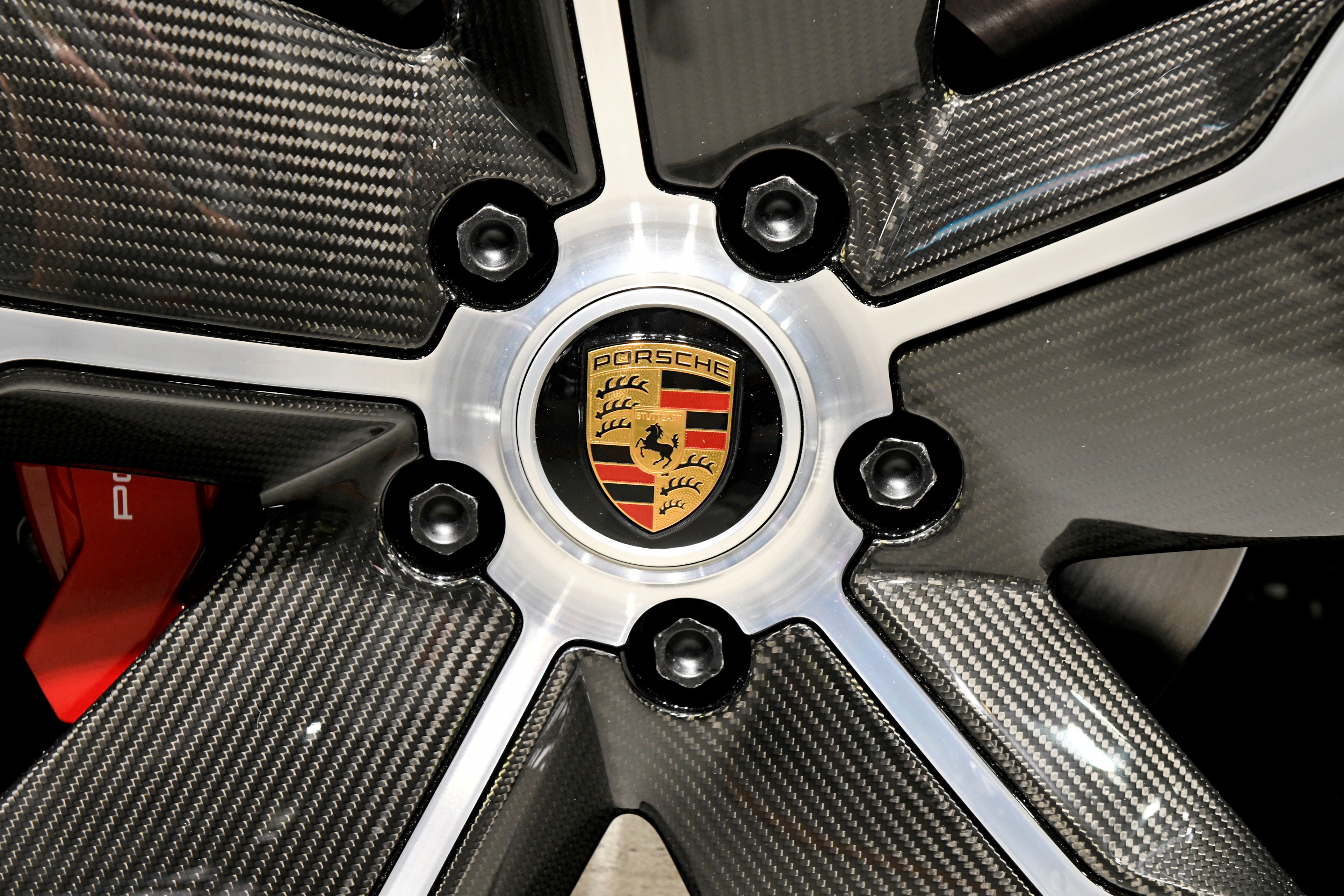 The Porsche logo is seen on wheel as Porsche's new Taycan 4S is revealed at the LA Auto Show in Los Angeles, California, U.S., November 20, 2019. REUTERS/Andrew Cullen/Files