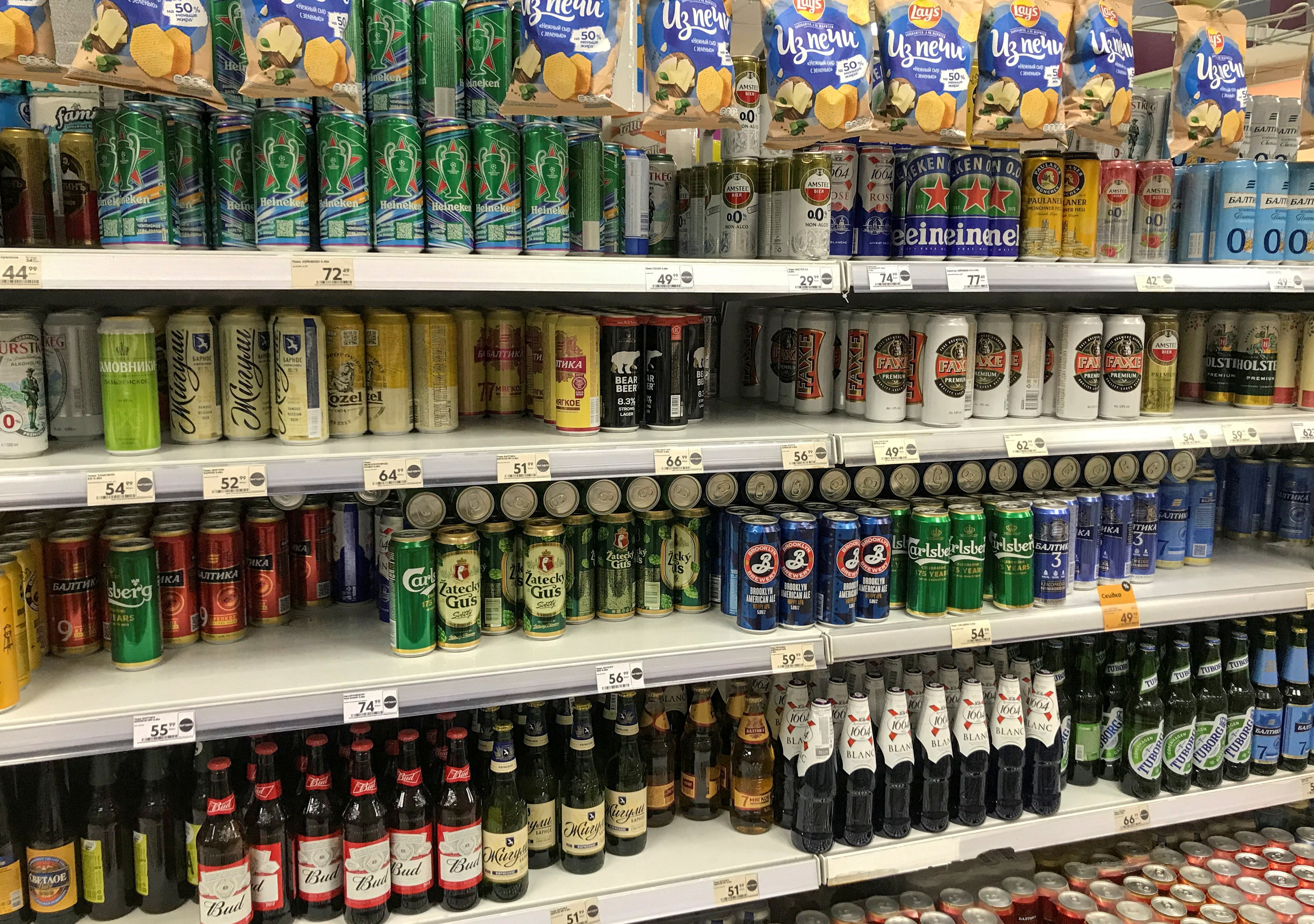 A view shows shelves with cans and bottles of beer at a shop in Moscow