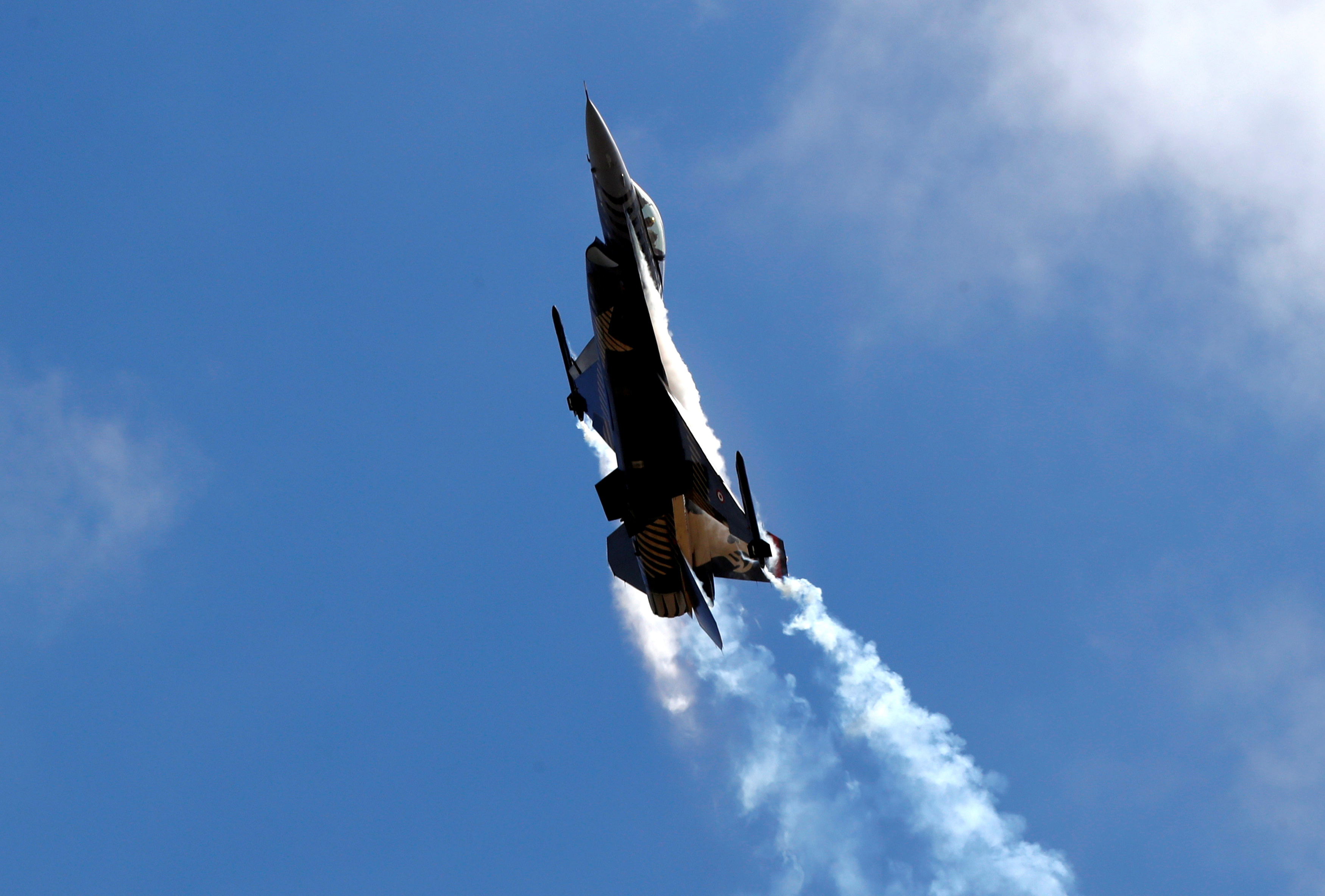 An F-16 aircraft of the Turkish Stars aerobatic team of the Turkish Air Force performs during Teknofest airshow over the city's new airport under construction in Istanbul