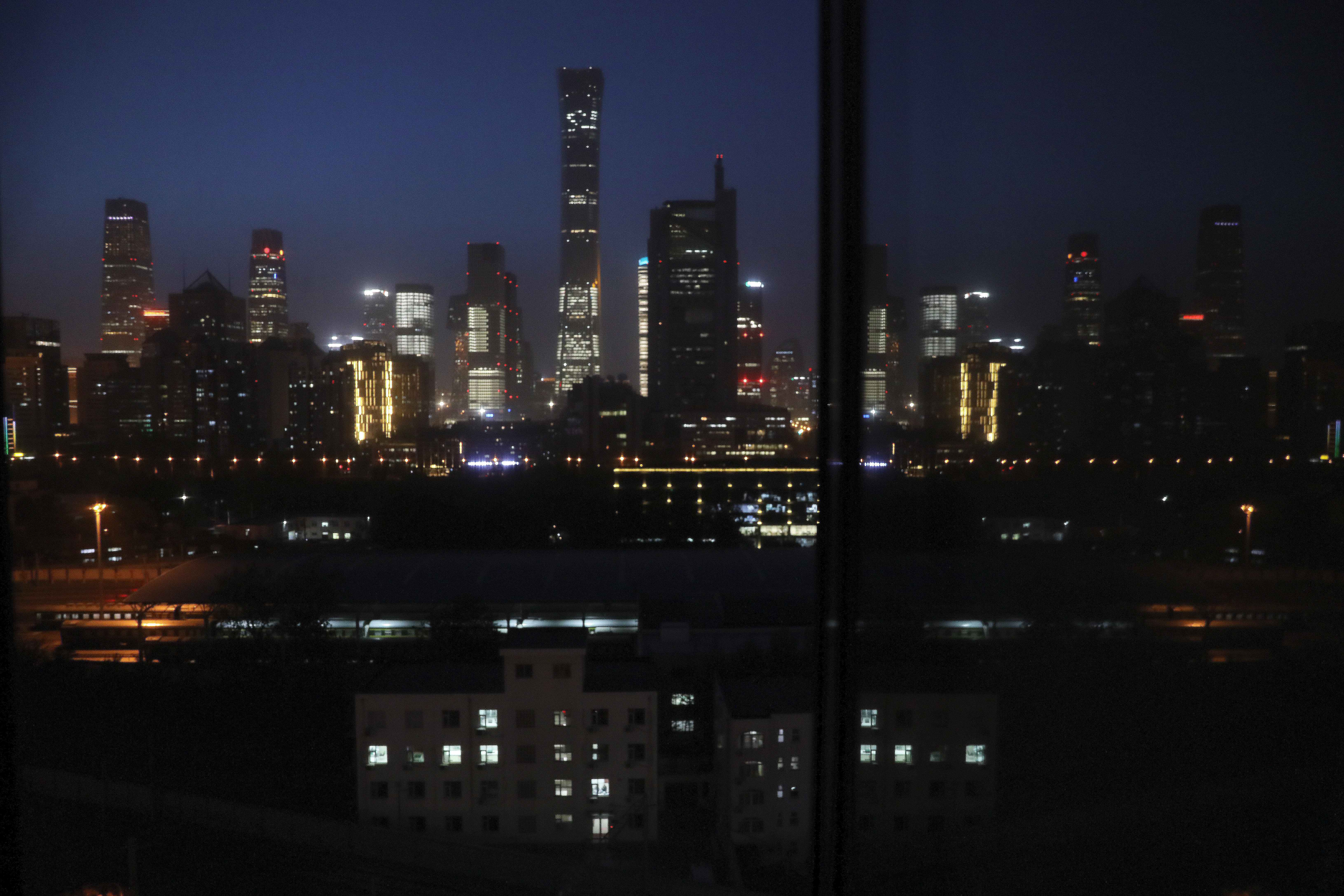 Buildings in the Central Business District (CBD) are seen lit up during the night in Beijing