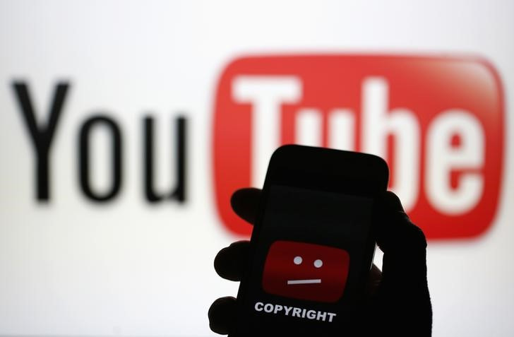 A picture illustration shows a photo taken of a YouTube error logo, displayed on a cell phone in front of a YouTube logo on an LCD screen, in central Bosnian town of Zenica