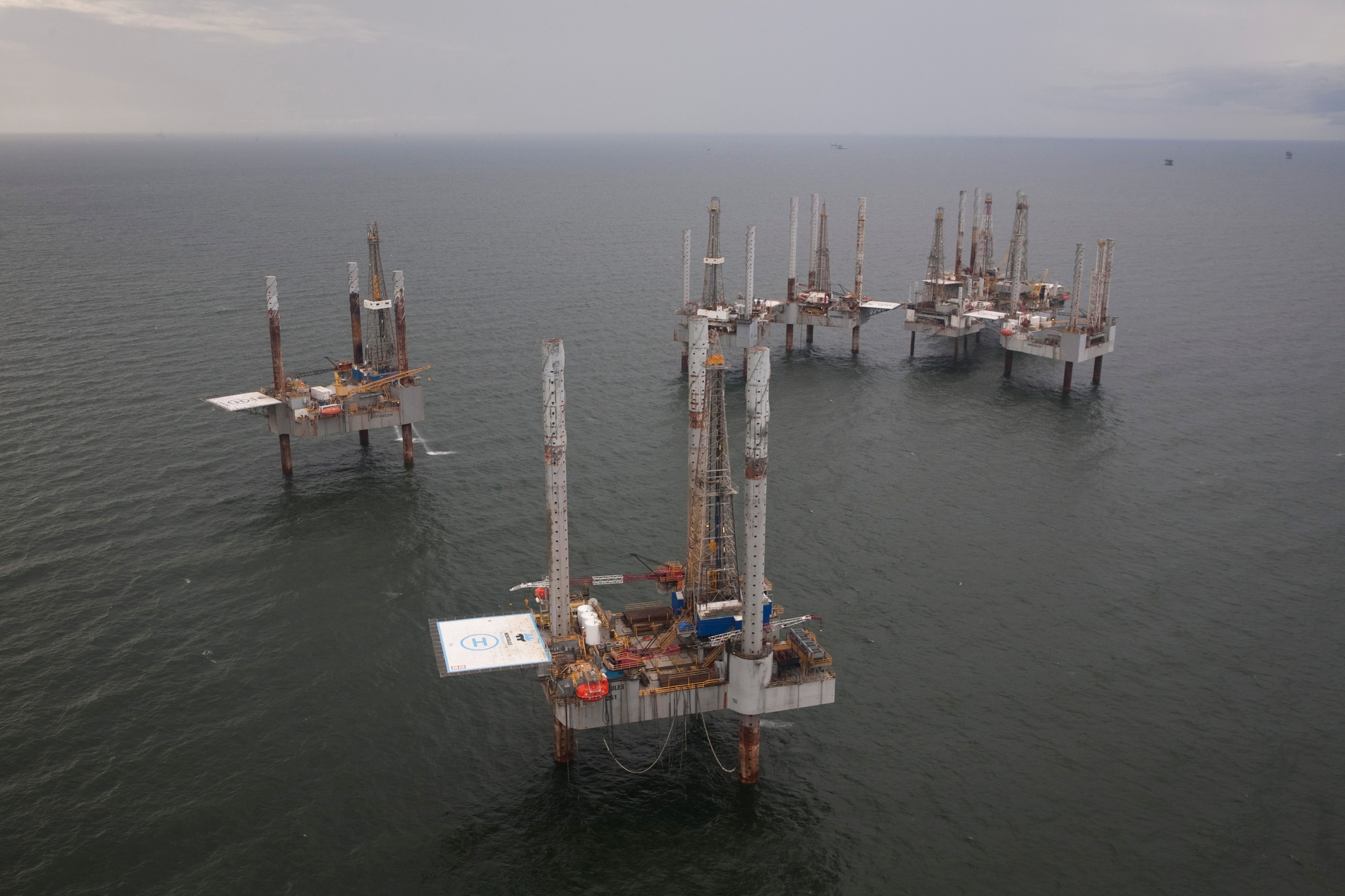 Unused oil rigs sit in the Gulf of Mexico near Port Fourchon, Louisiana August 11, 2010. REUTERS/Lee Celano/File Photo