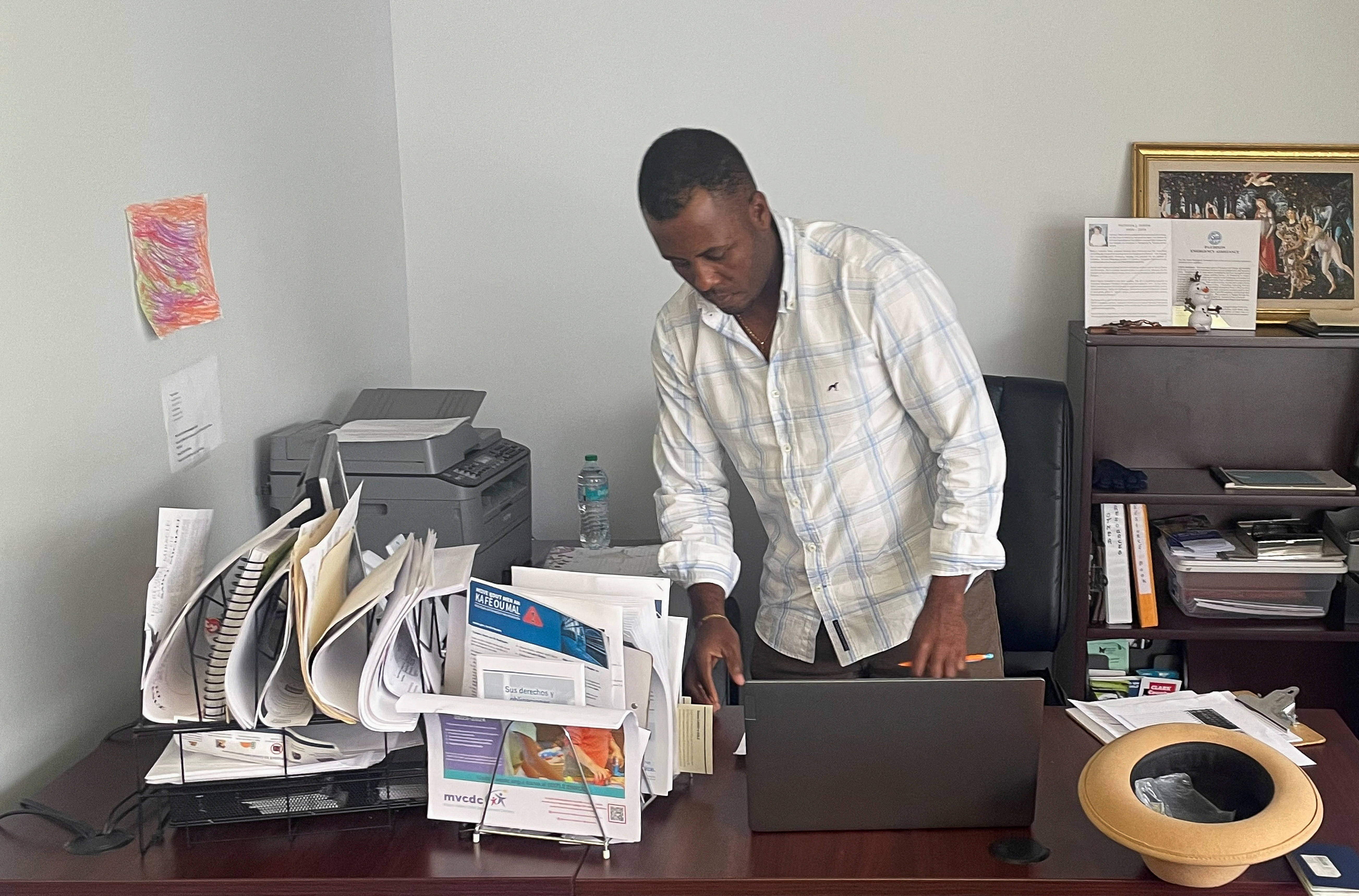 Bansal Oreus helps other Haitian immigrants with government documents at the St. Vincent de Paul Society in Springfield