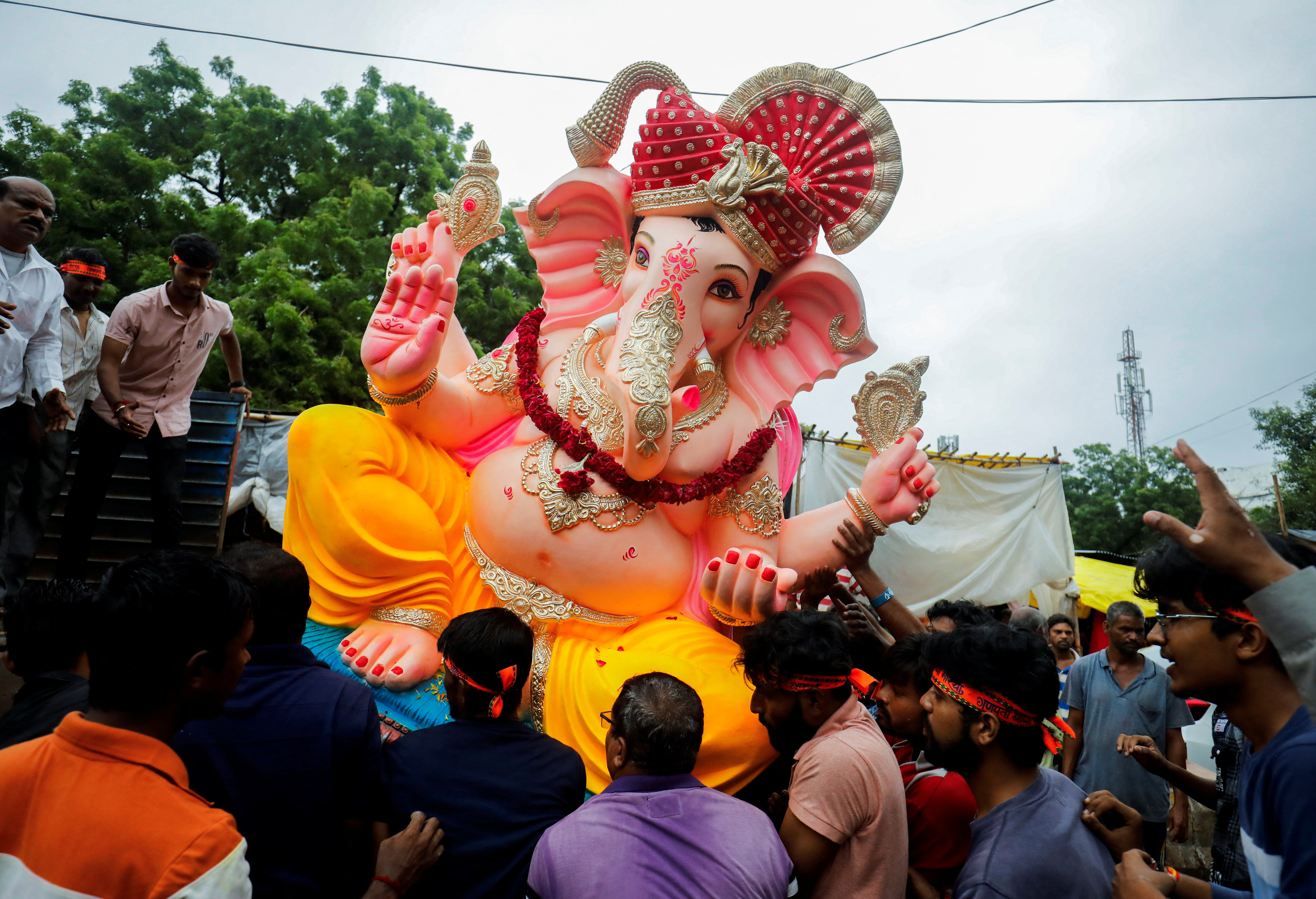 Devotees load an idol of the Hindu god Ganesh onto a truck to be transported to a place of worship during ten-day-long Ganesh Chaturthi festival in Ahmedabad