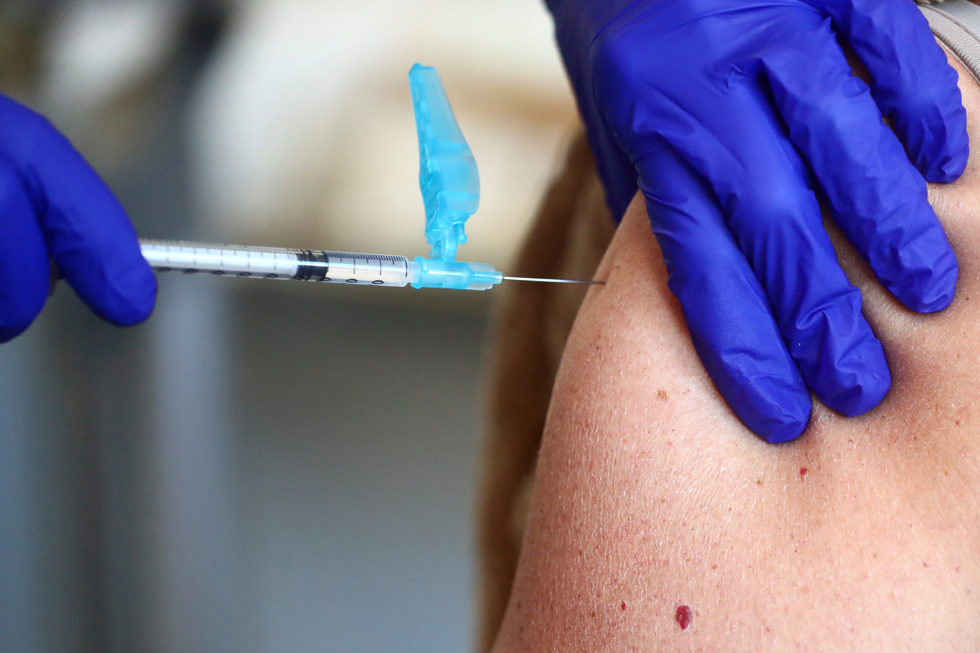 Health worker receives an injection with a dose of the Pfizer-BioNTech COVID-19 vaccine, in Madrid